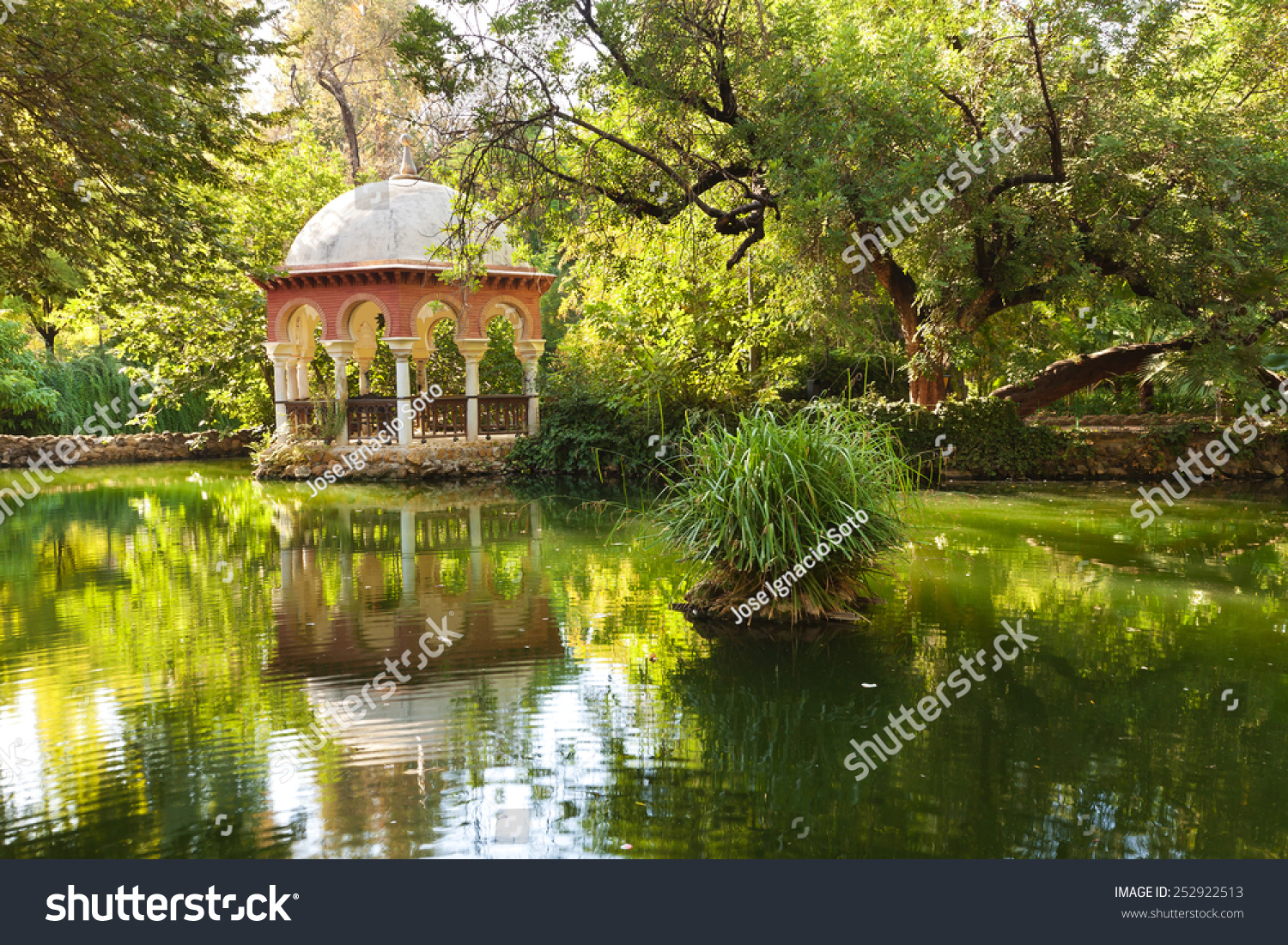 Romantic pavilion reflected in a pond. Parque Maria Luisa of Sevilla  Spain 