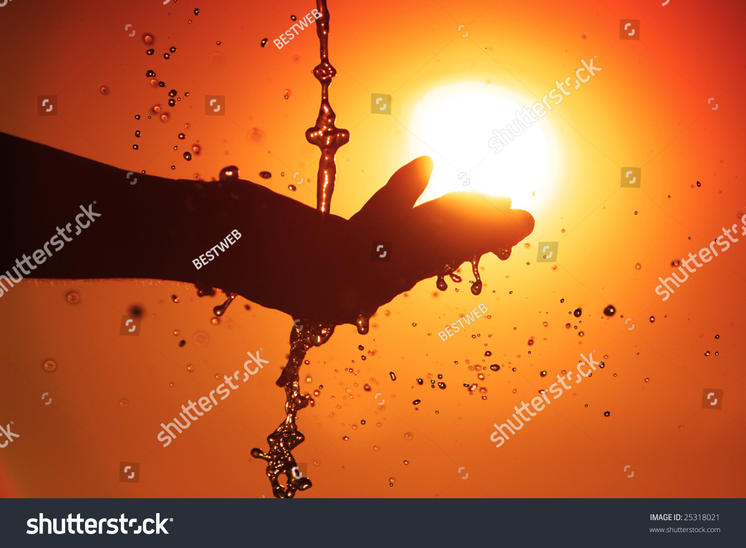Abstract spout of water to the hand and beautiful sunset