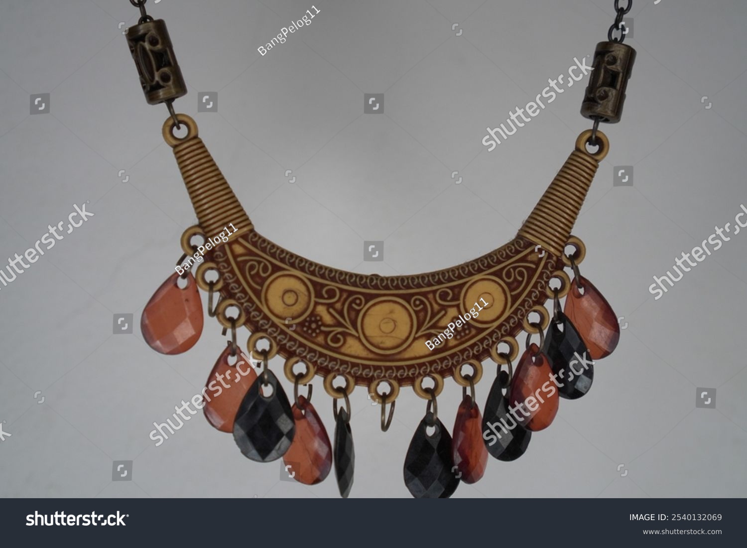 Upgrade your look with this unique bohemian necklace. It features a handmade crescent moon pendant with detailed carvings  plus dangling amber and black beads. This necklace combines vintage charm