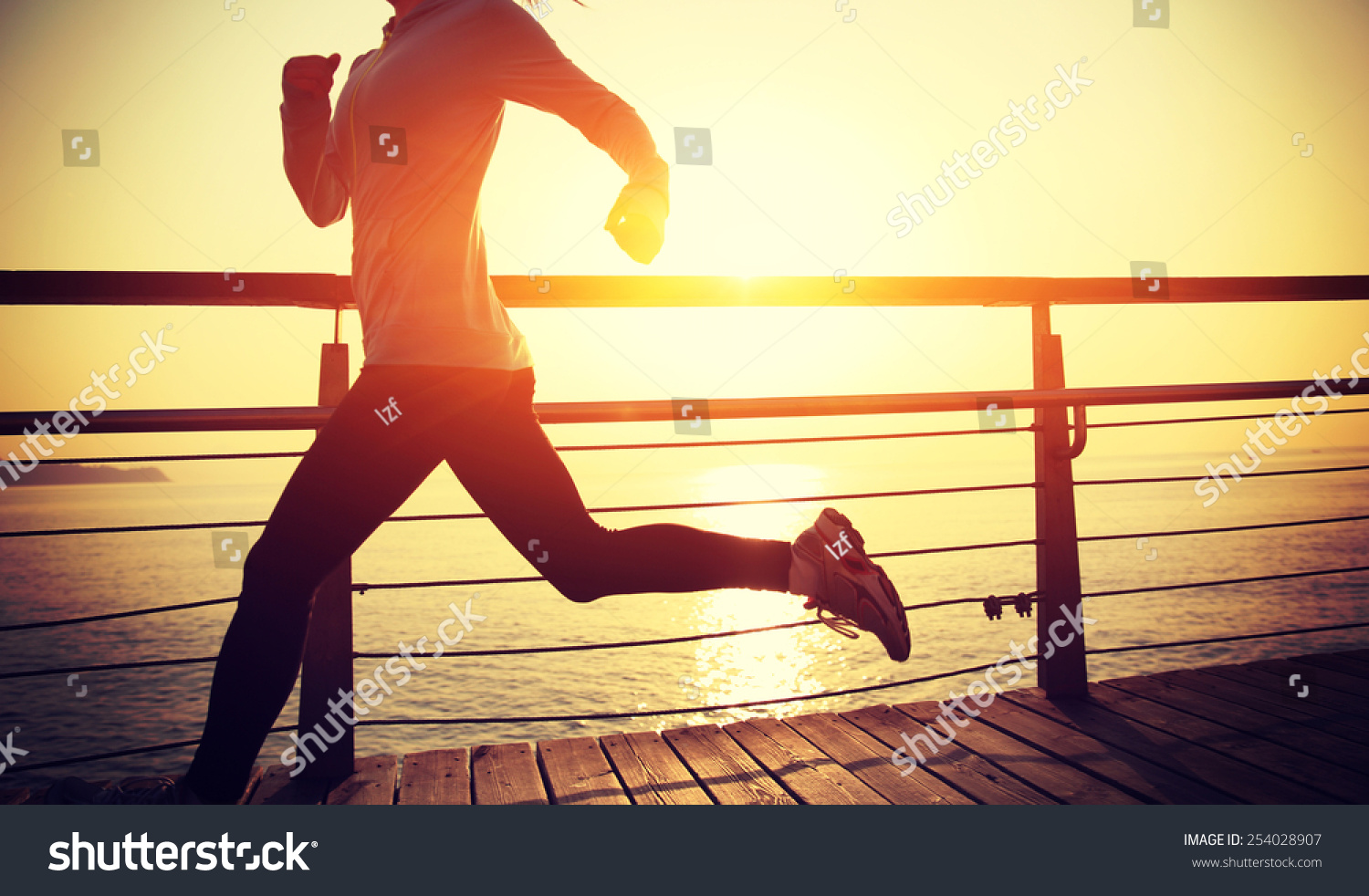 healthy lifestyle sports woman running on wooden boardwalk sunrise ...