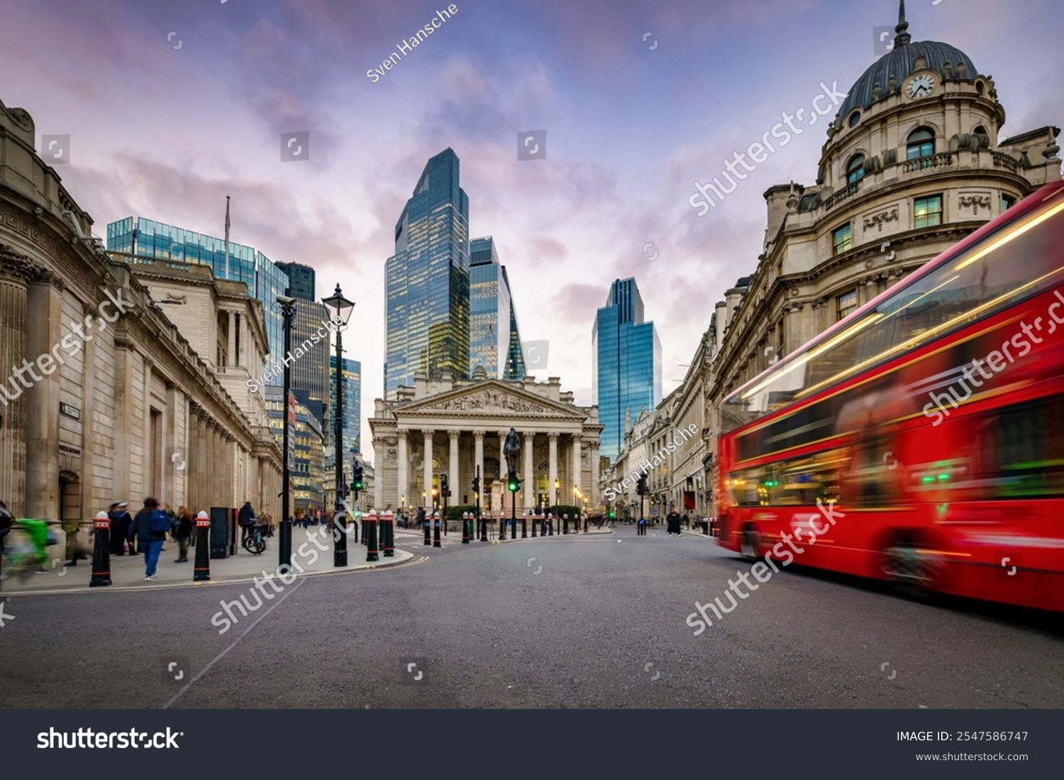 Sunset view of the City of London  England  with commuter and street traffic in front of the Bank of England