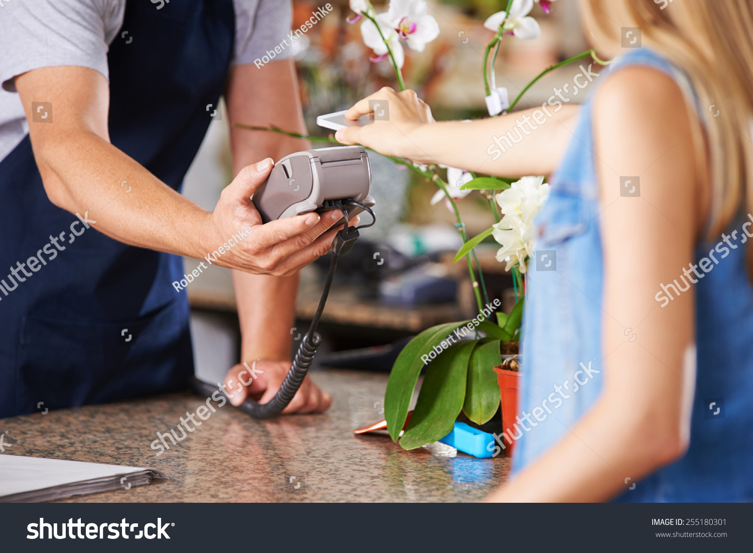 Mobile Payment with smartphone at checkout in nursery retail store