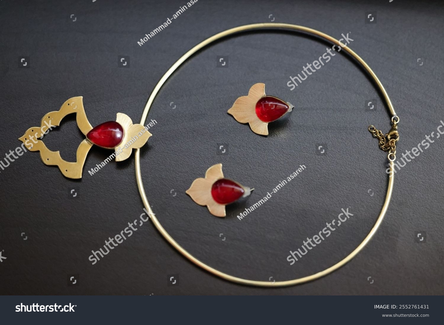 Product photography of Persian handmaid jewelry containing necklace  earrings  and rings 