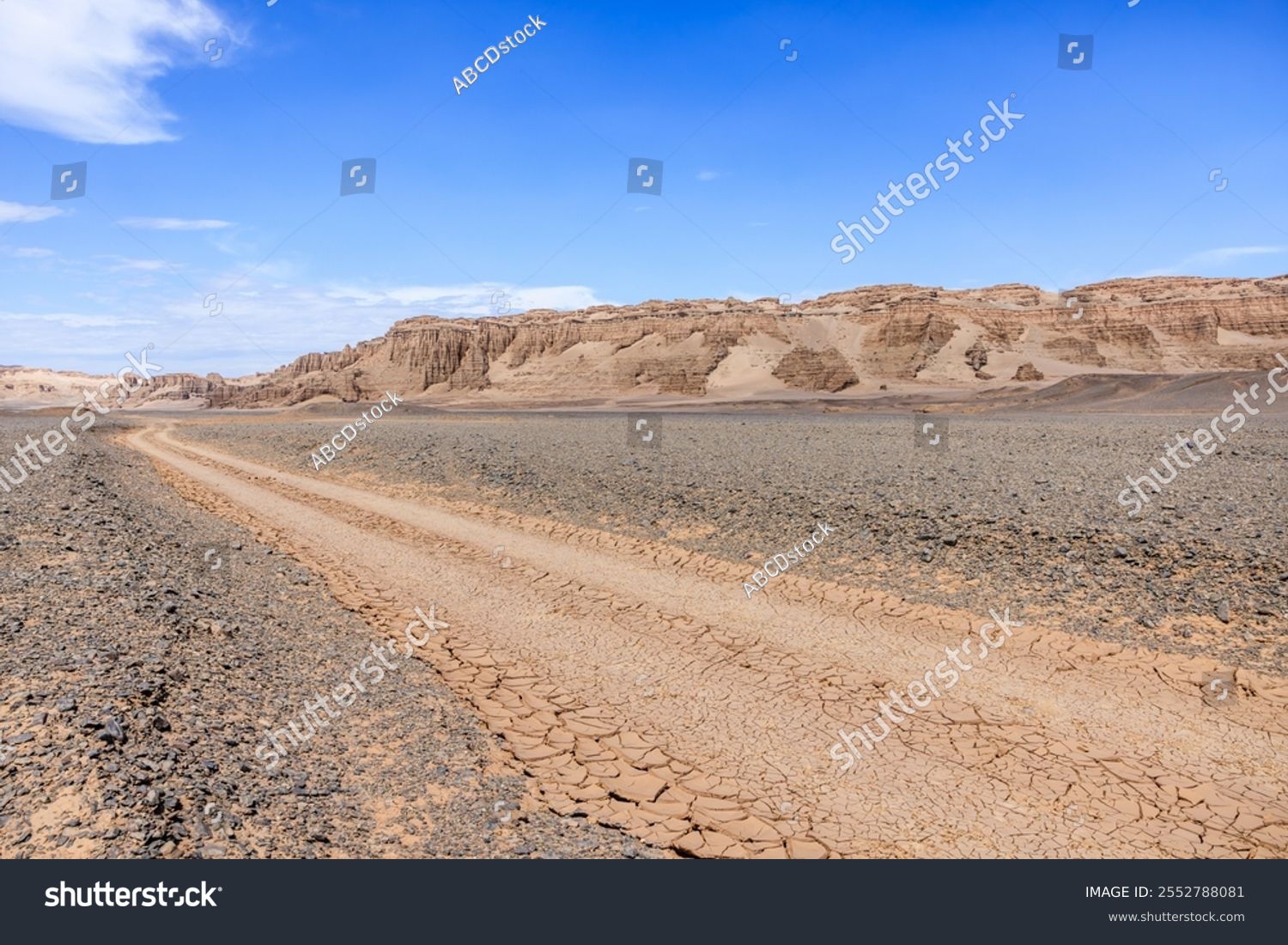 Desert dirt road and mountain natural landscape in Xinjiang  China. Road trip in no man's land. Outdoor natural background.