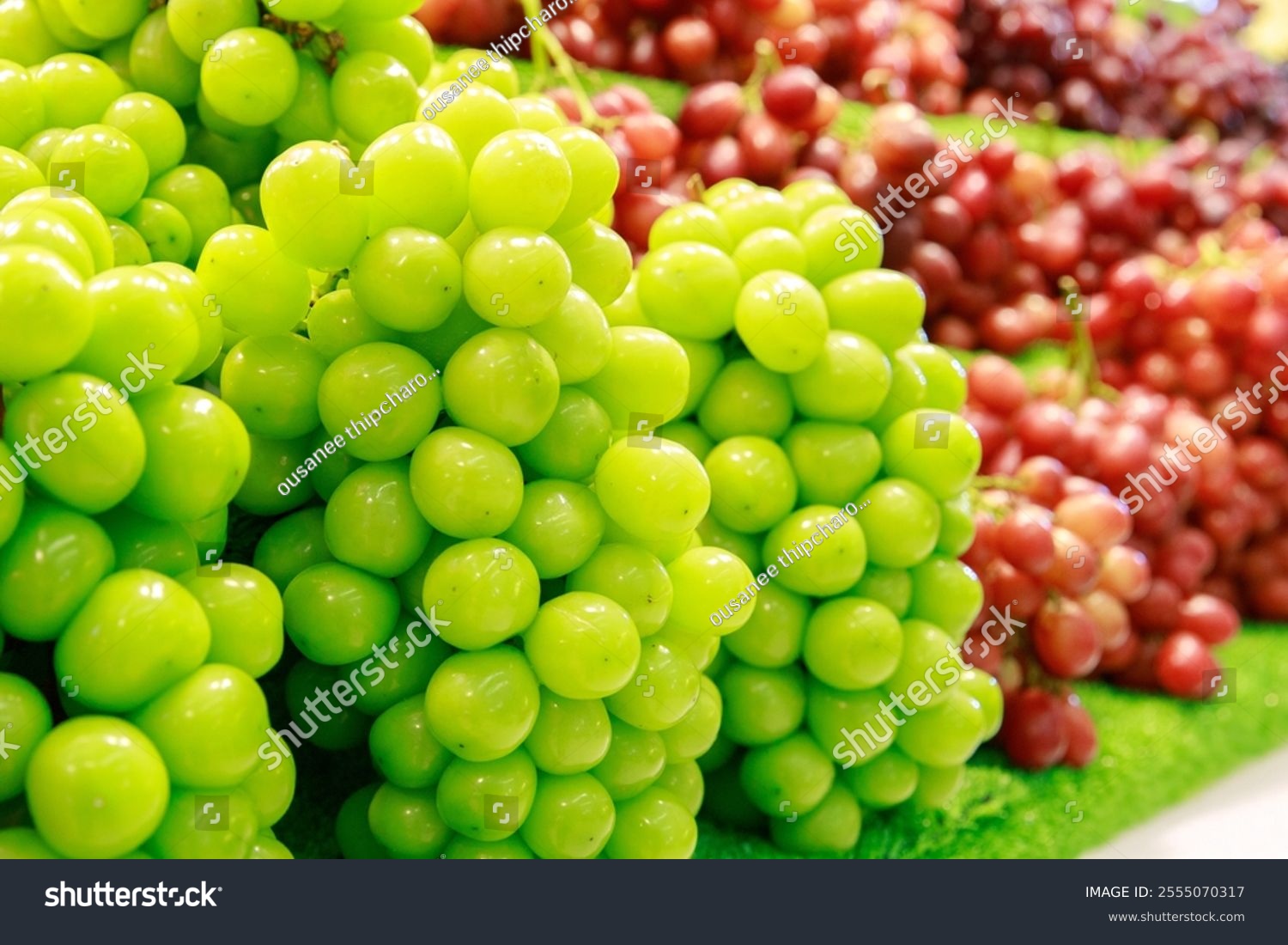 Shine Muscat grape  closeup  behind red grapes  sale on the shelf