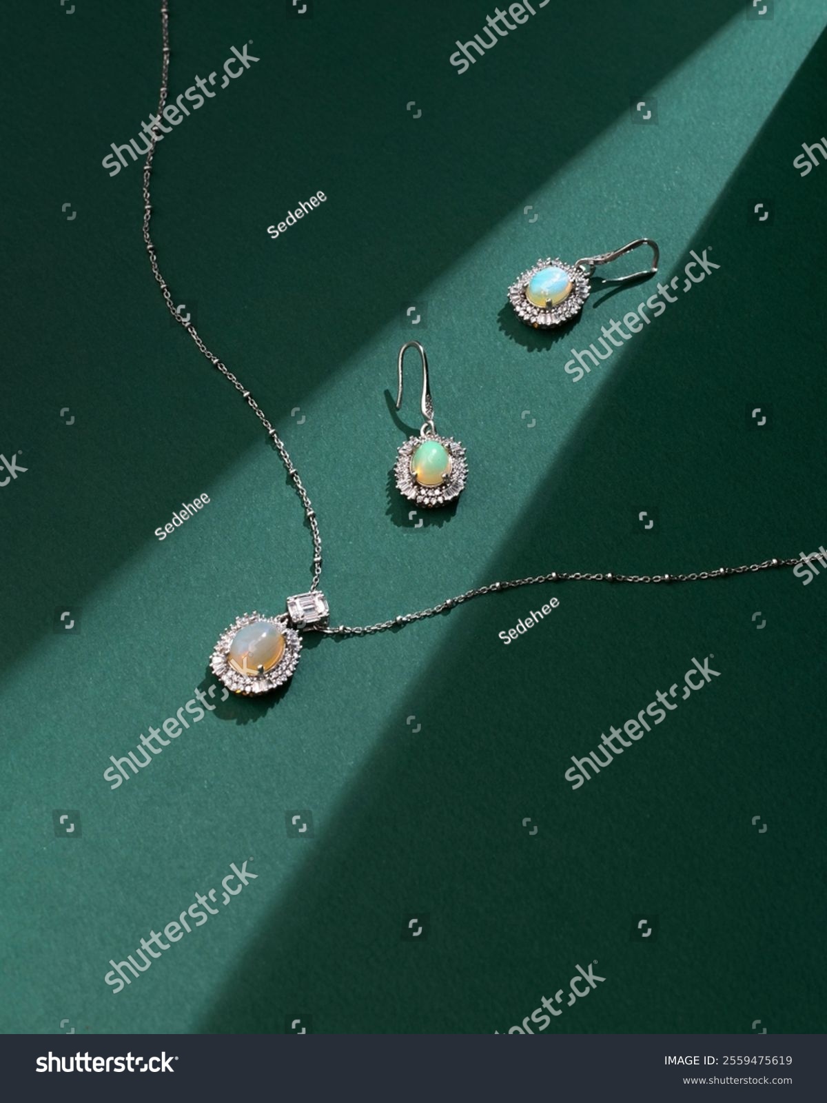 Elegant opal jewelry set featuring a necklace and earrings  beautifully styled on a green background with soft shadows
