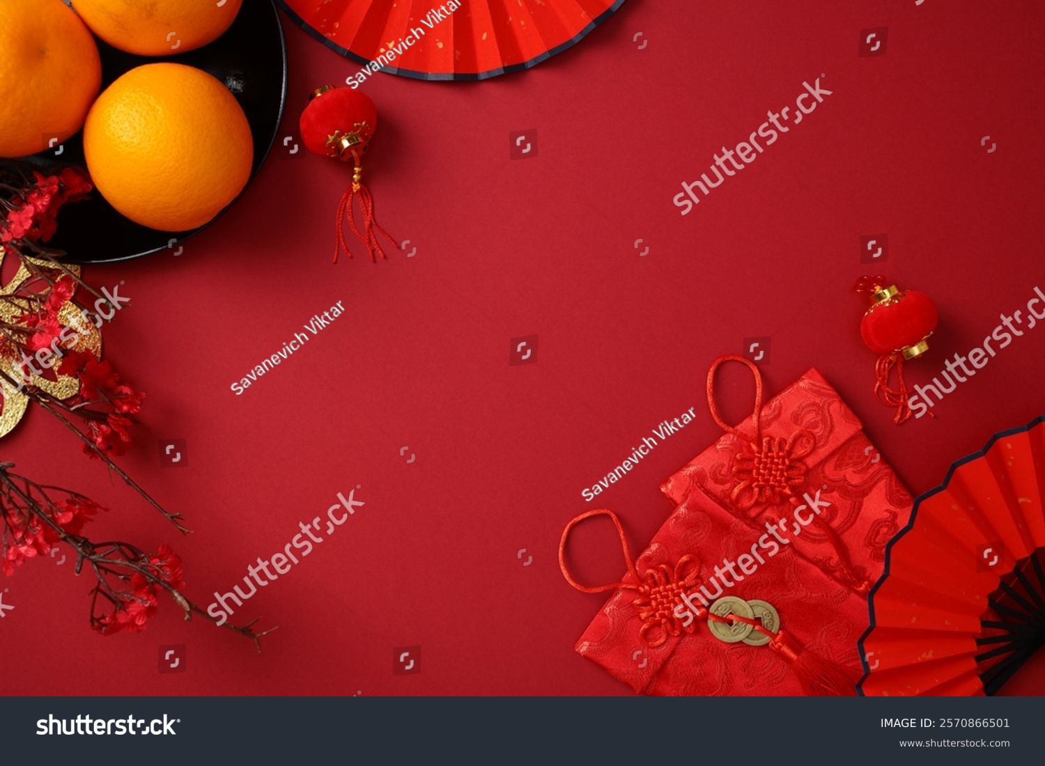 Chinese New Year 2025 flat lay composition with tangerines cherry blossoms red paper fans lanterns on red background