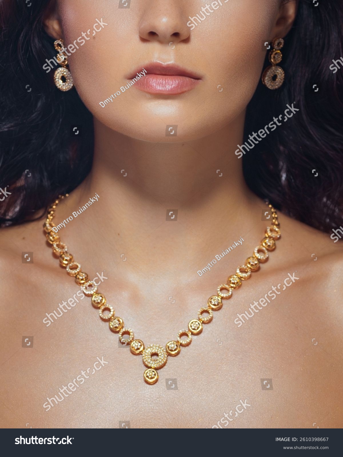 Elegant close-up of a woman's neck and face with a sparkling gold necklace and earrings. High quality jewelry image perfect for fashion  accessories  and luxury branding promos.