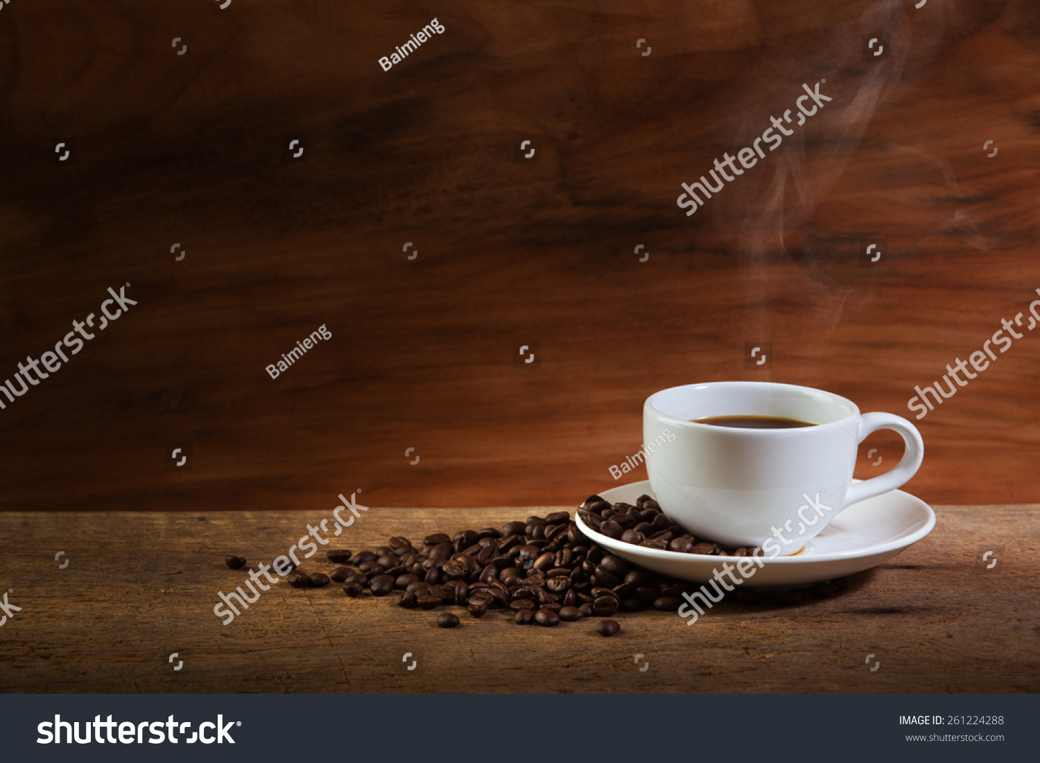 Coffee cup and coffee beans with stream on old wooden background