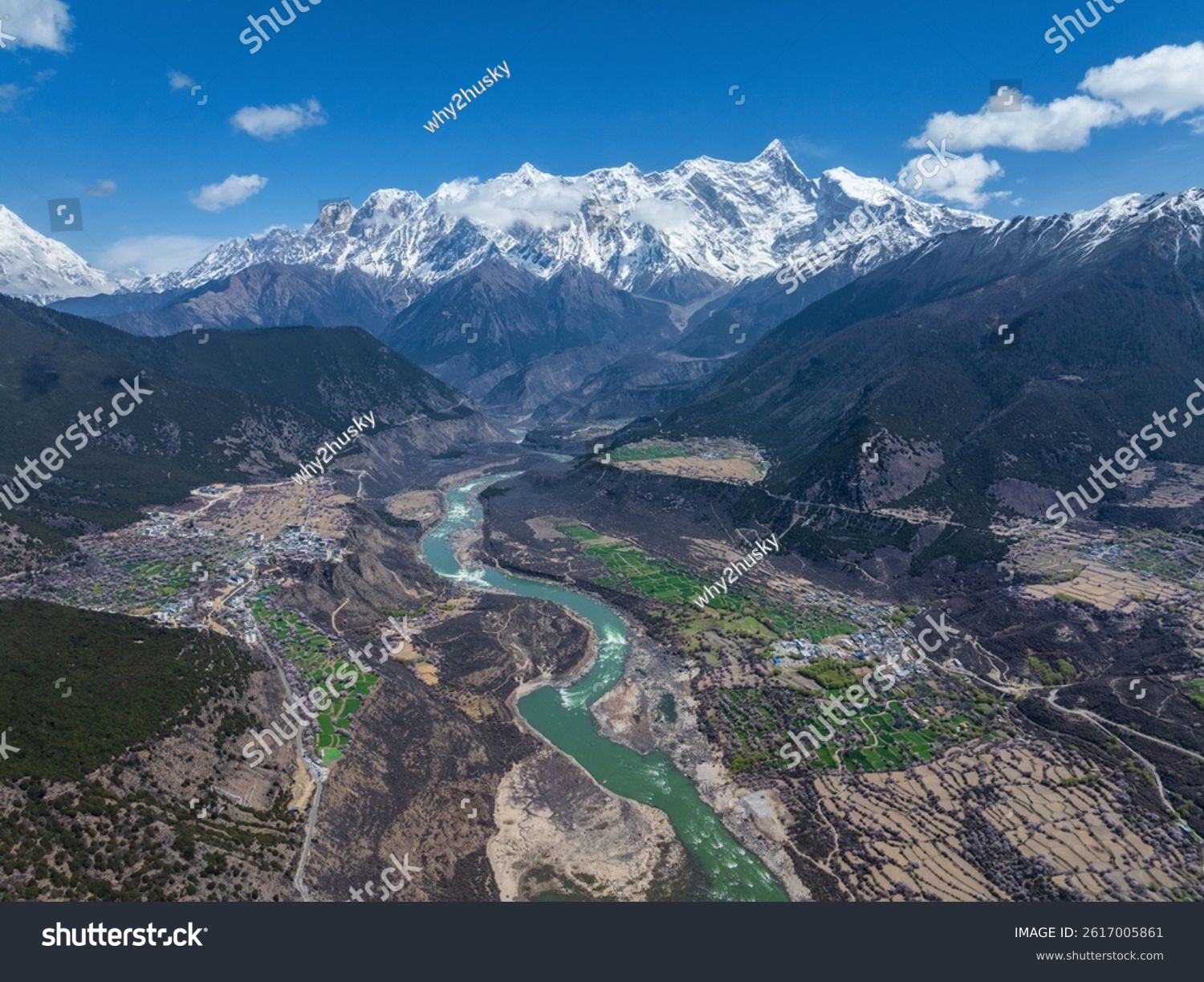 Nyingchi Tibet China - 7th April 2025 - Beautiful peach blossoms along Yarlung Zangbo River and high angle view of Namjagbarwa Peak