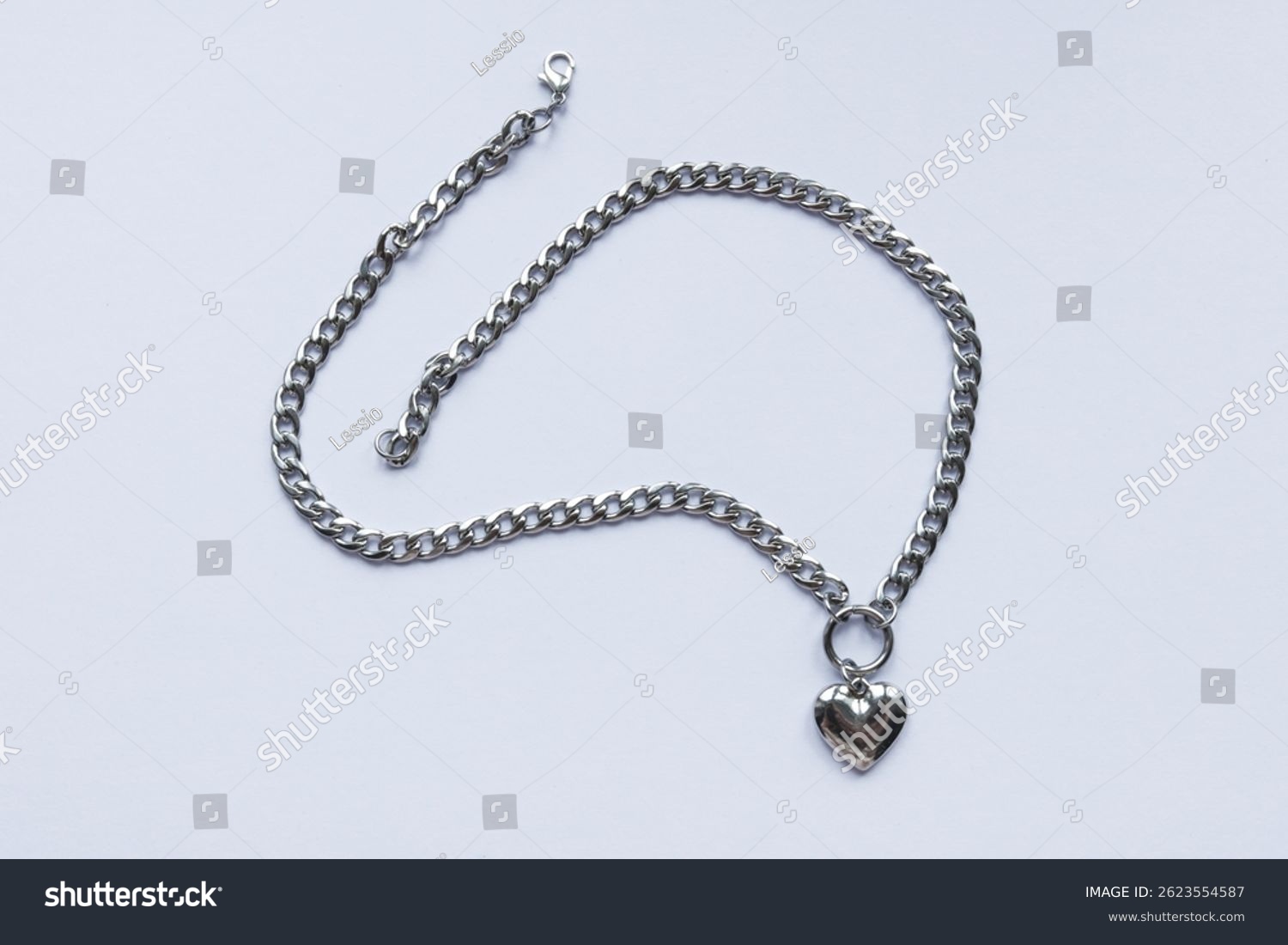 Silver necklace with a heart on a white background  close-up