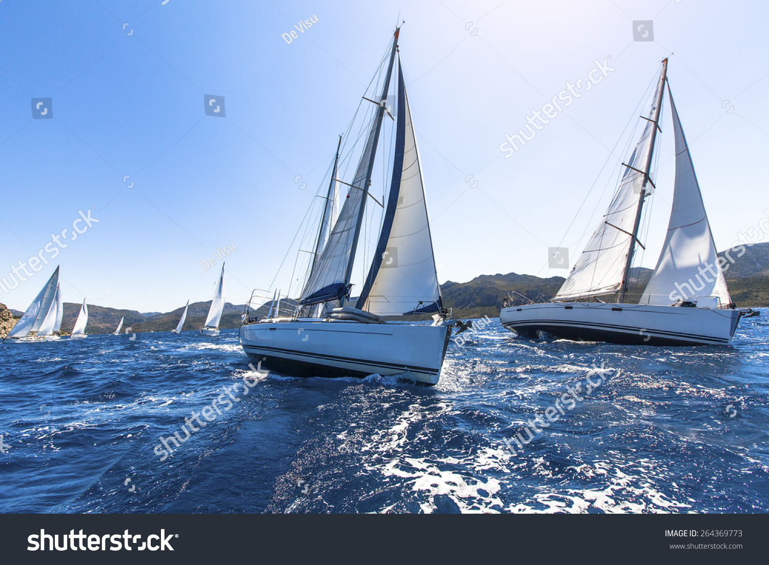 Sailing in the wind through the waves at the Aegean Sea in Greece. Sailing regatta. Luxury yachts.