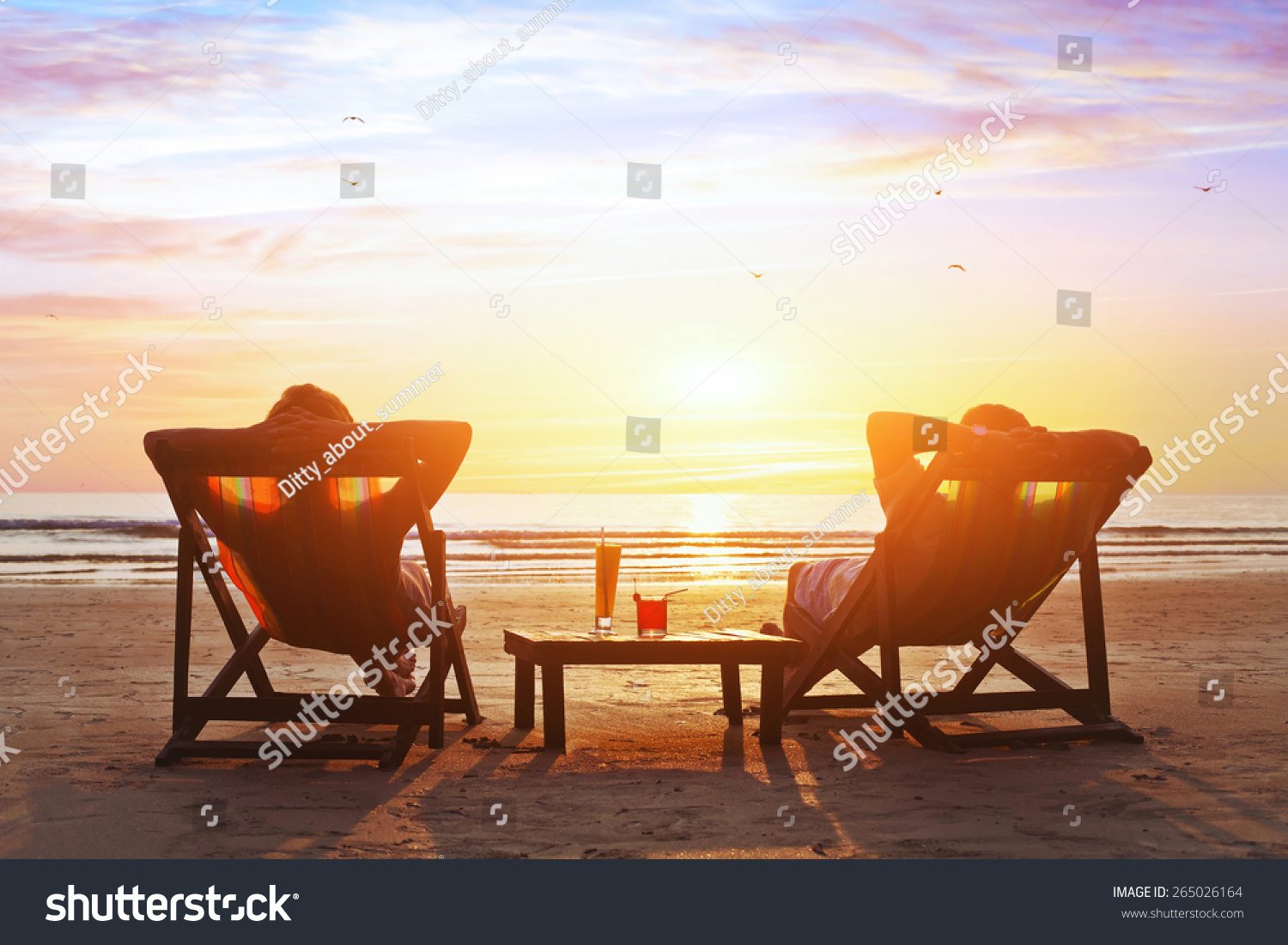 happy couple enjoy luxury sunset on the beach during summer vacations