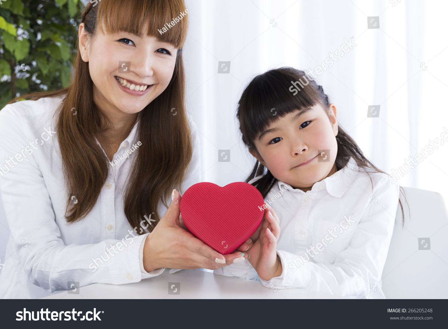 little girl has a gift box in her hand