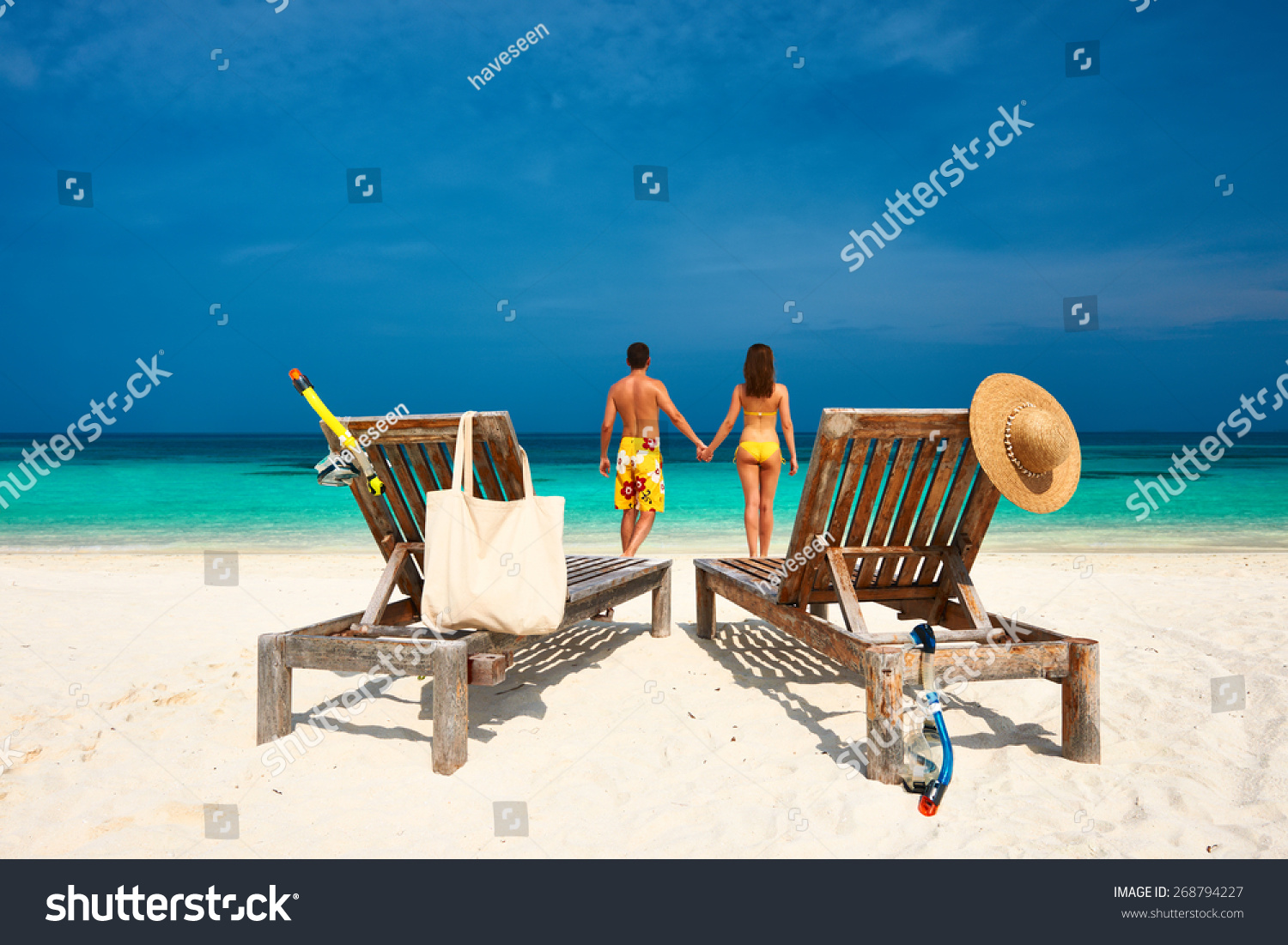 Couple in yellow on a tropical beach at Maldives