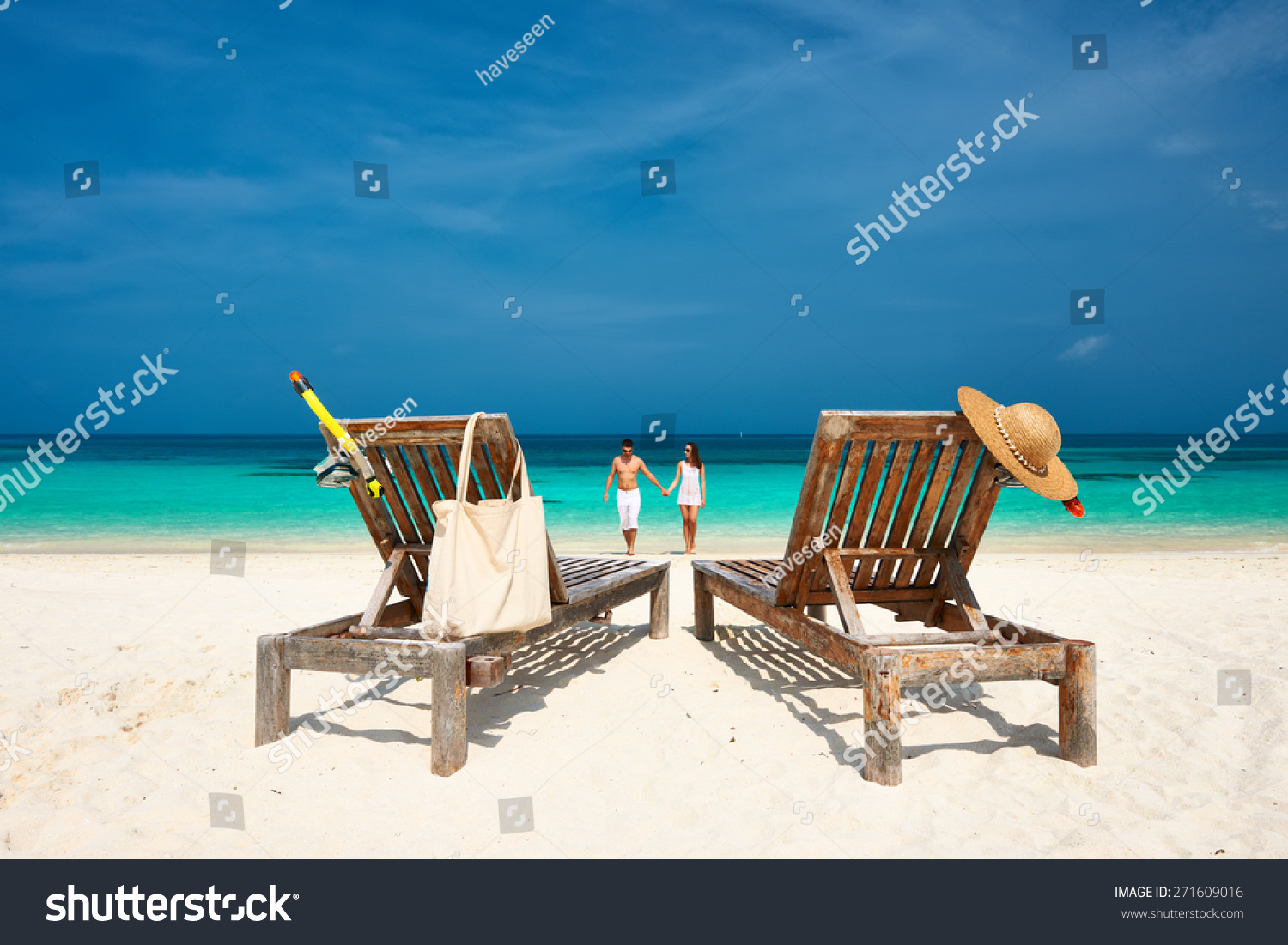 Couple in white walking on a tropical beach at Maldives