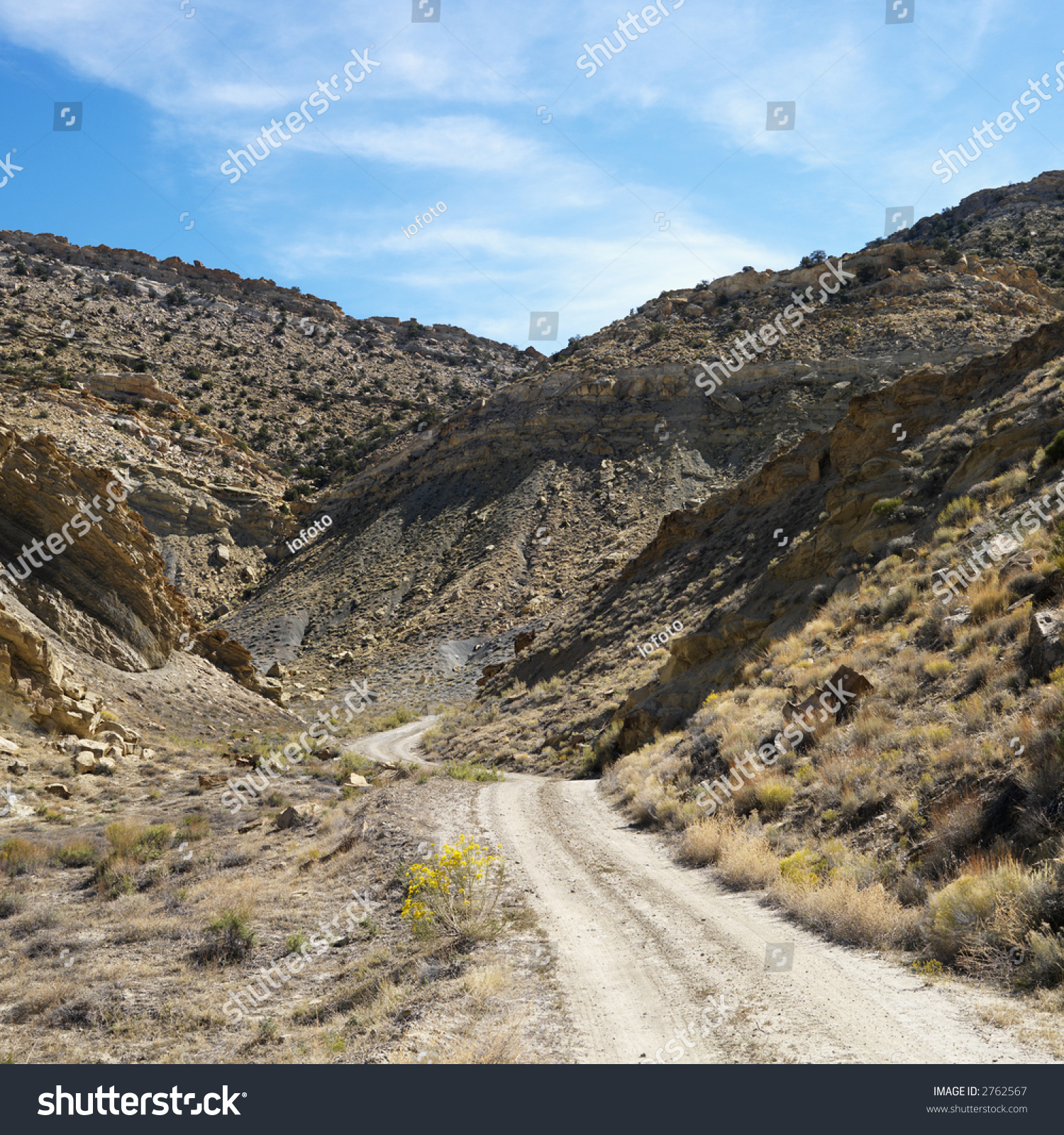 dirtroadwindingthroughrockydesertcliffsofcottonwoodcanyonutah