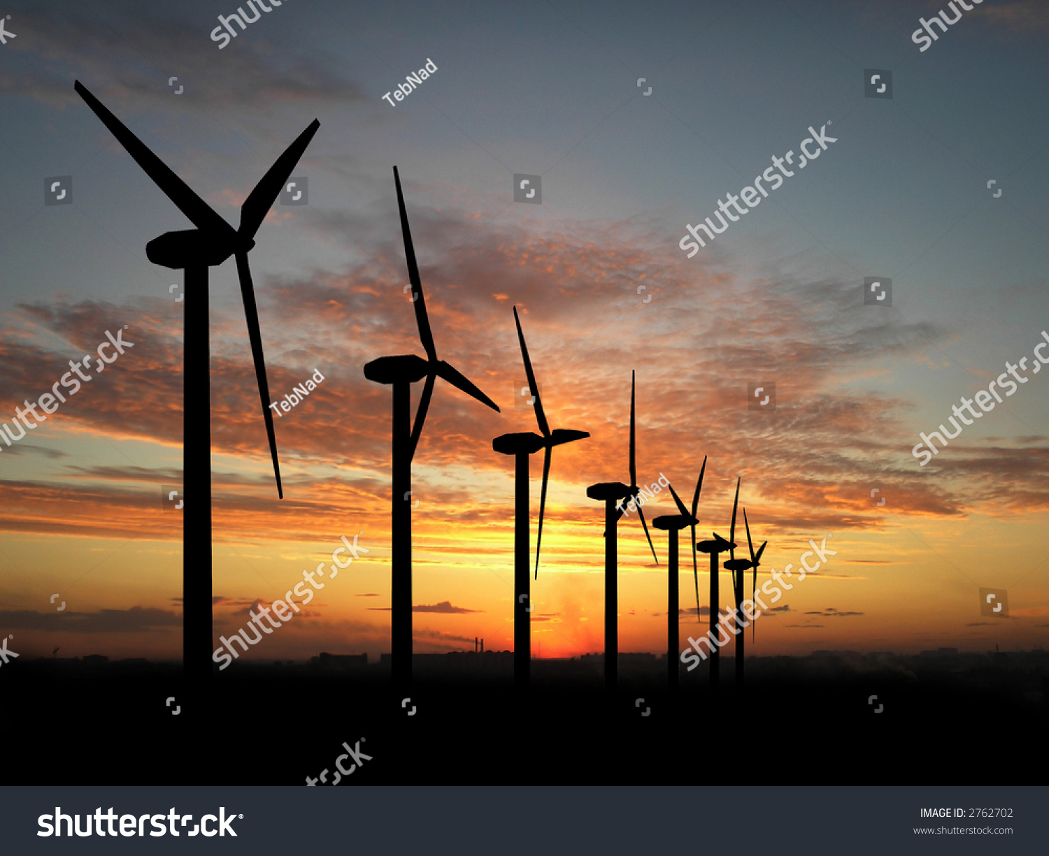Wind turbine farm over sunset