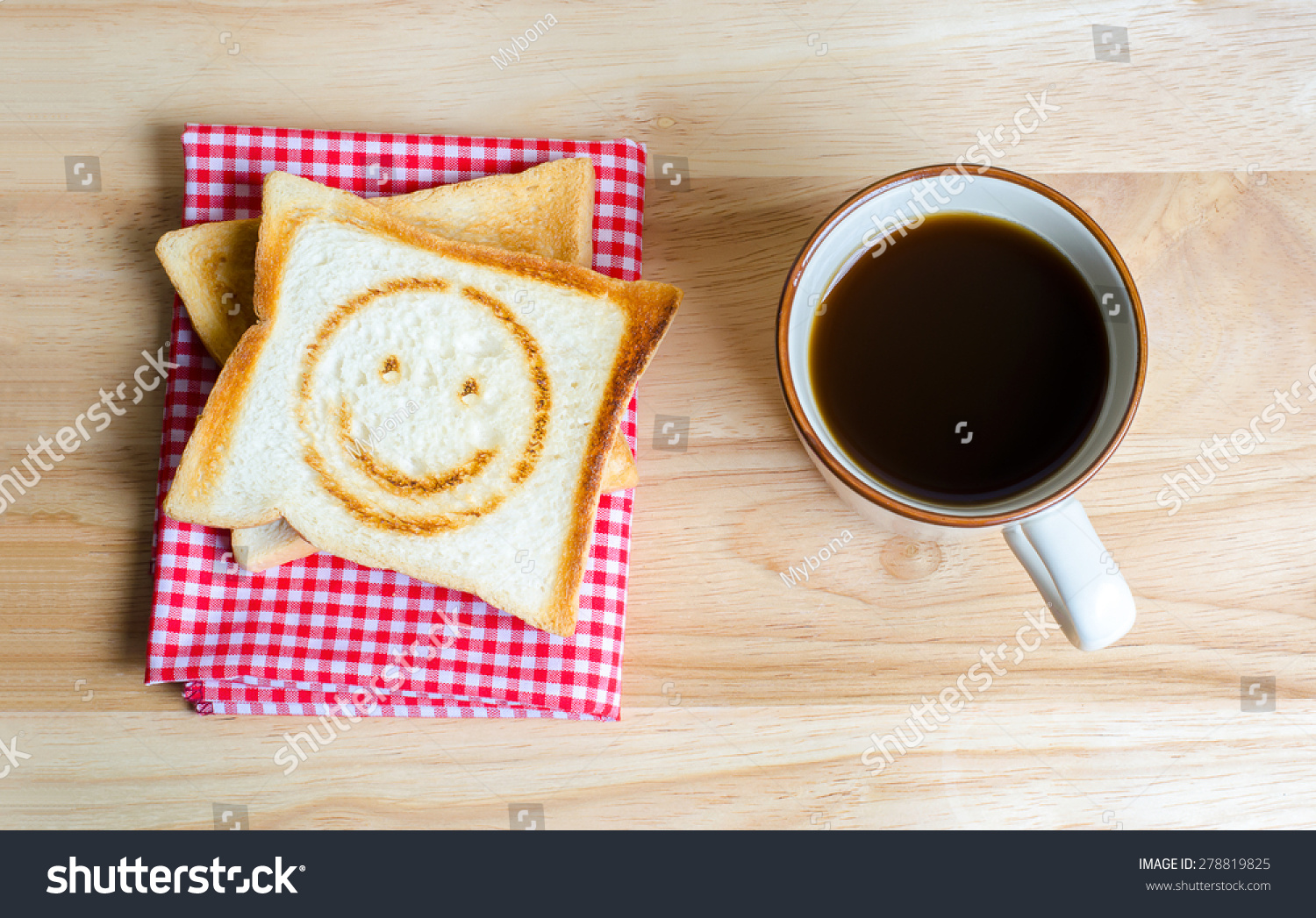 Coffee and toasts on wooden table