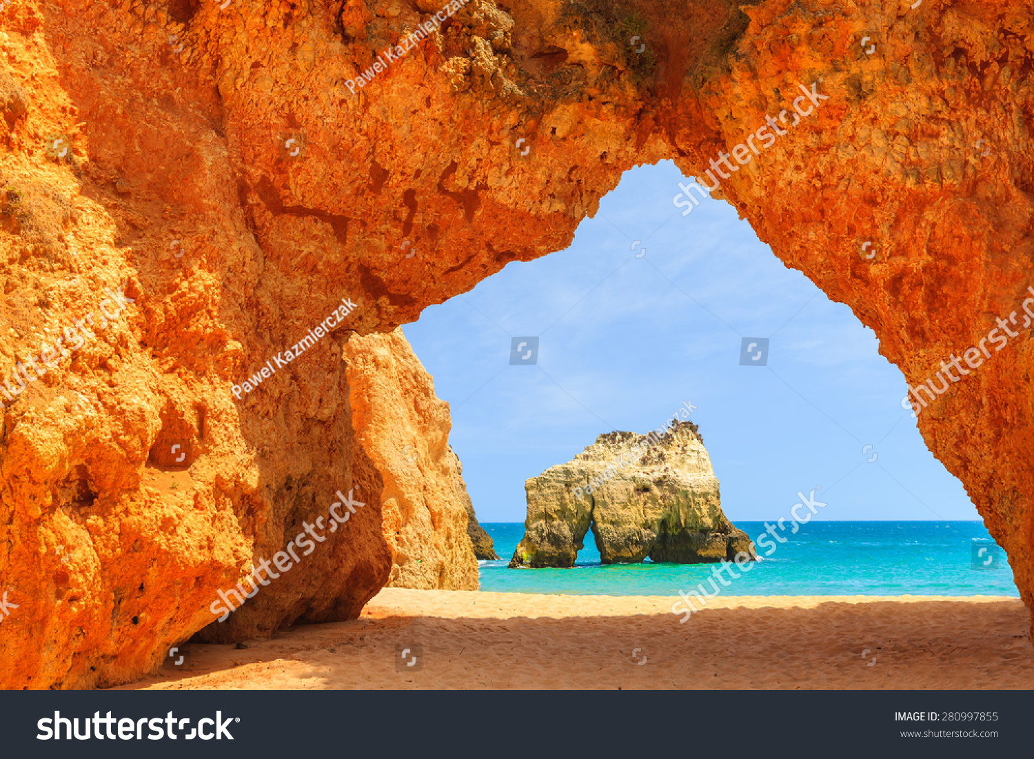 Arch of a cliff rock on Alvor beach and view of sea  Portugal