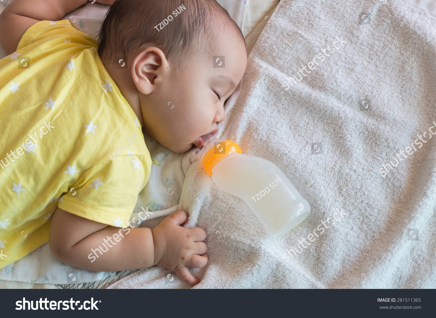 Asian baby sleeping and drinking milk