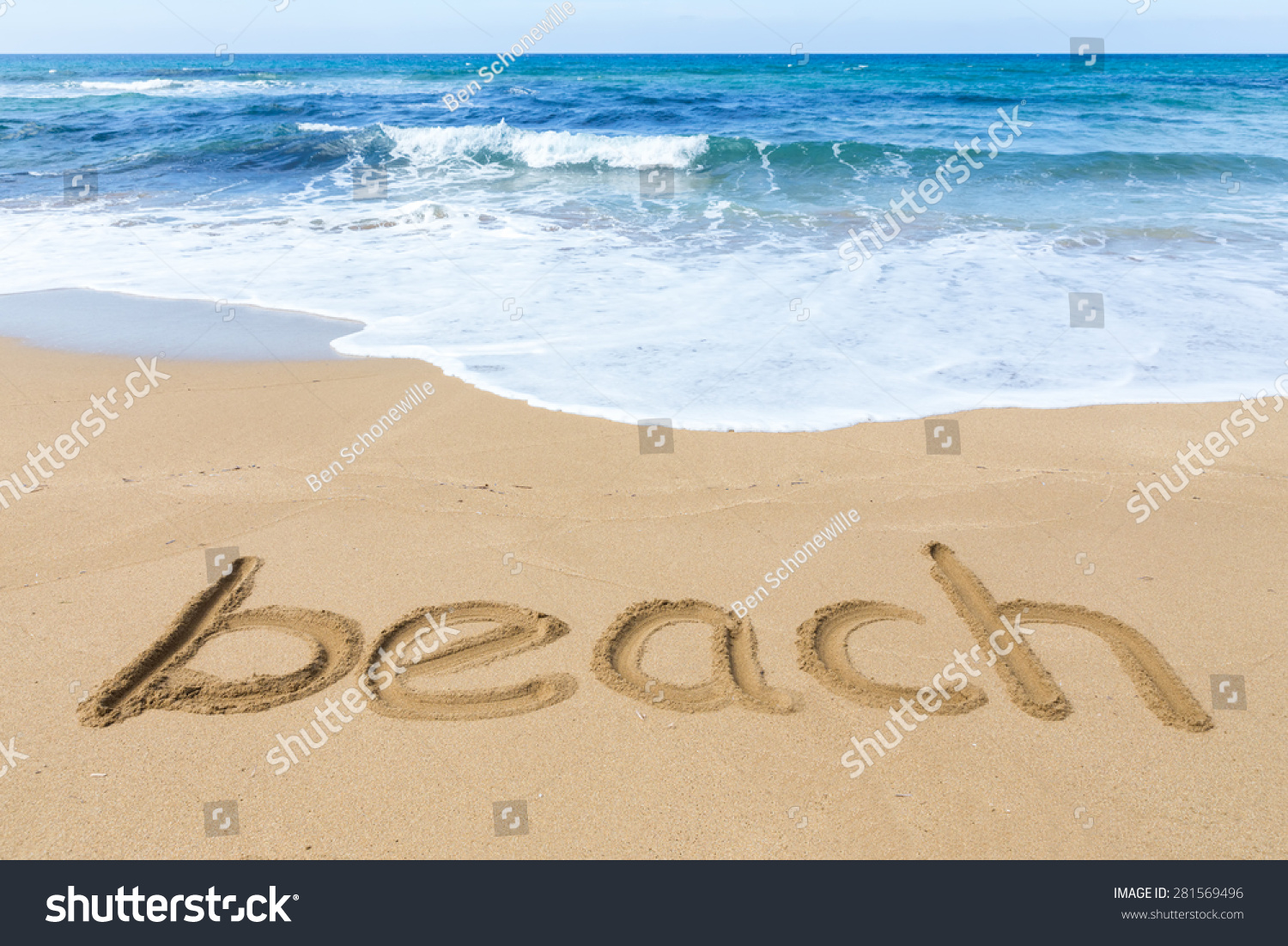 Word beach on sandy coast with blue sea and water waves
