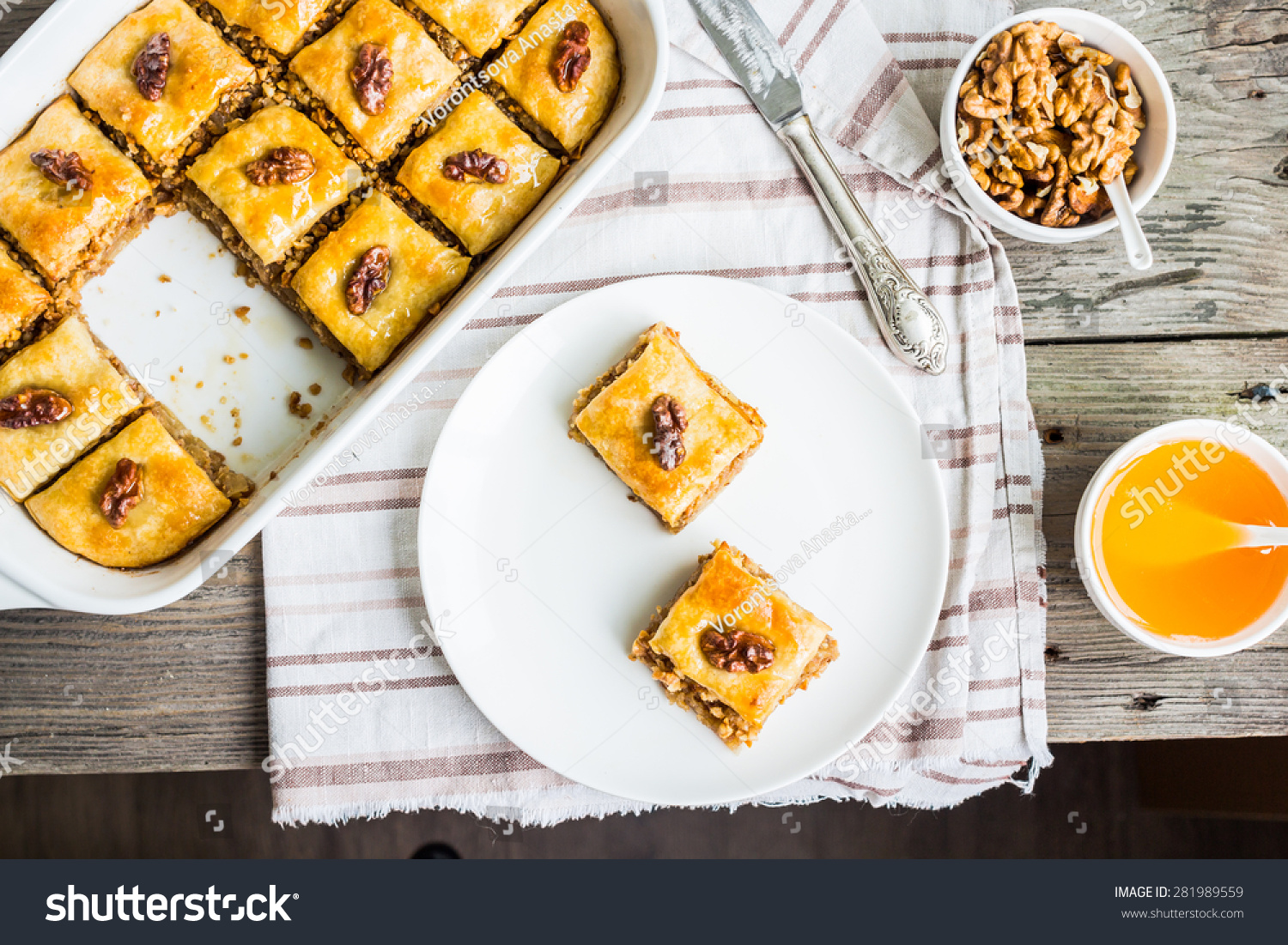 pieces of baklava with honey and nuts on a plate  top view  rustic  traditional Turkish dessert