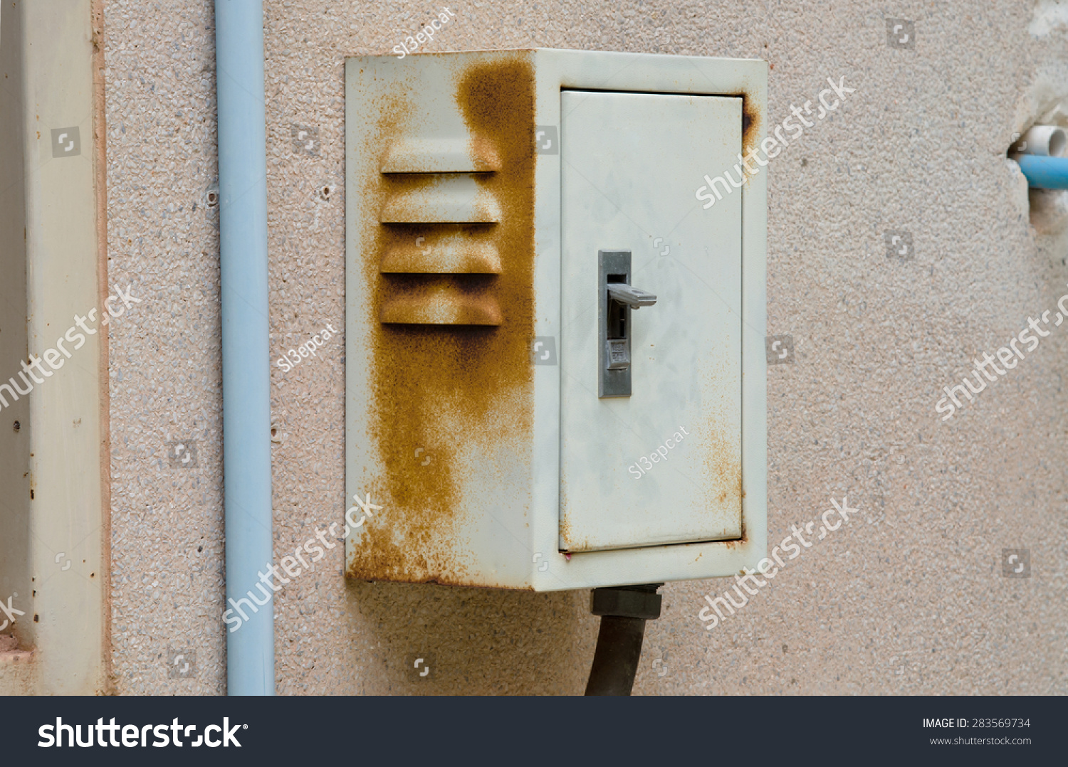 Rusty breaker box on old dirty wall.