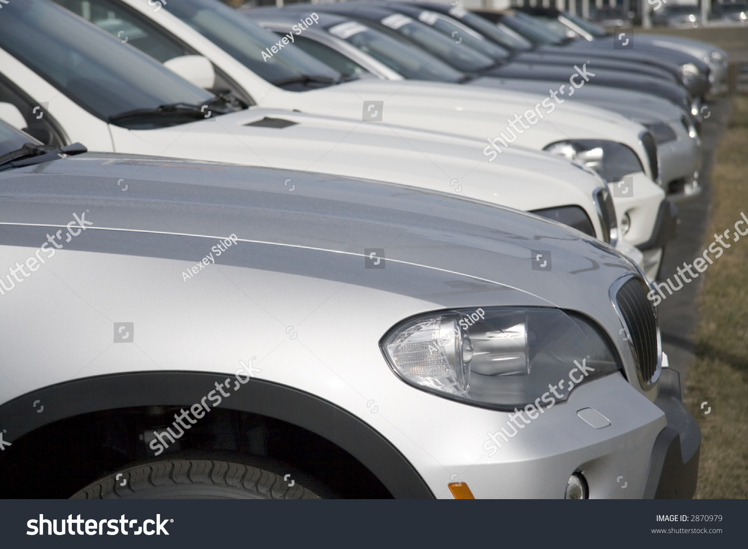 Row of brand new cars at dealership lot