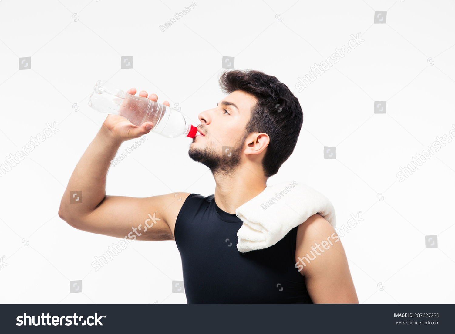 Sports man drinking water with bottle isolated on a white background
