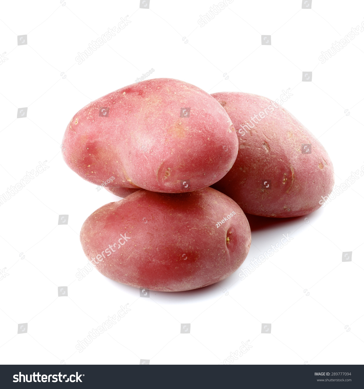 three big raw red fingerling potatoes isolated on white back