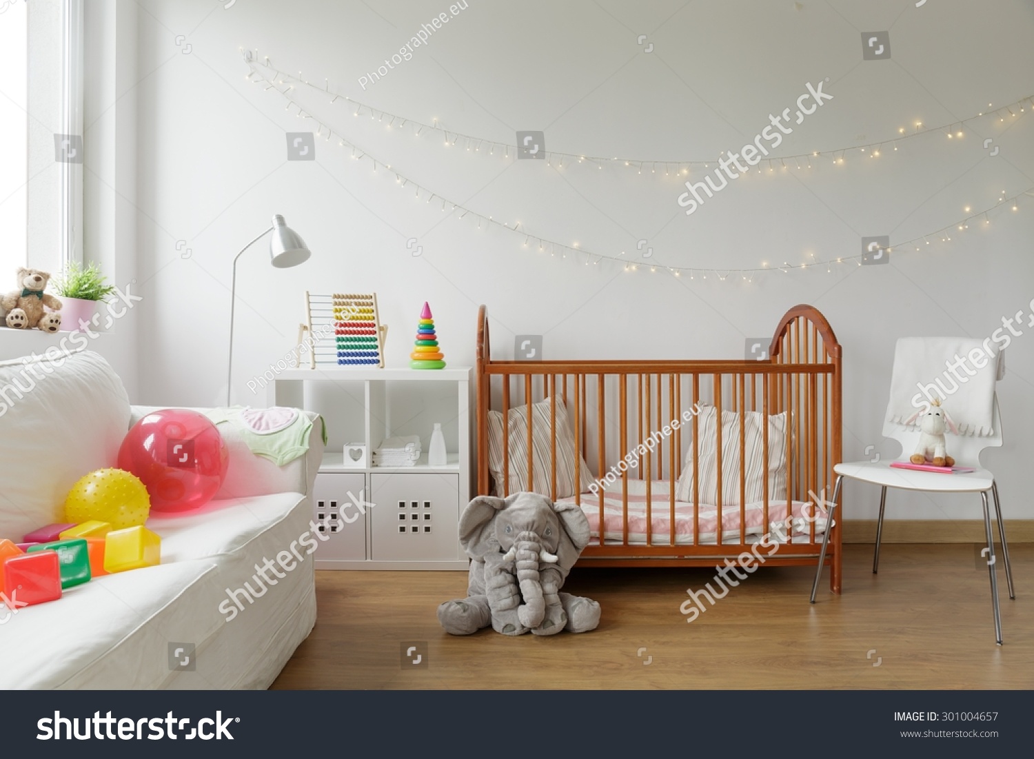 Photo of white and cosy newborn room interior