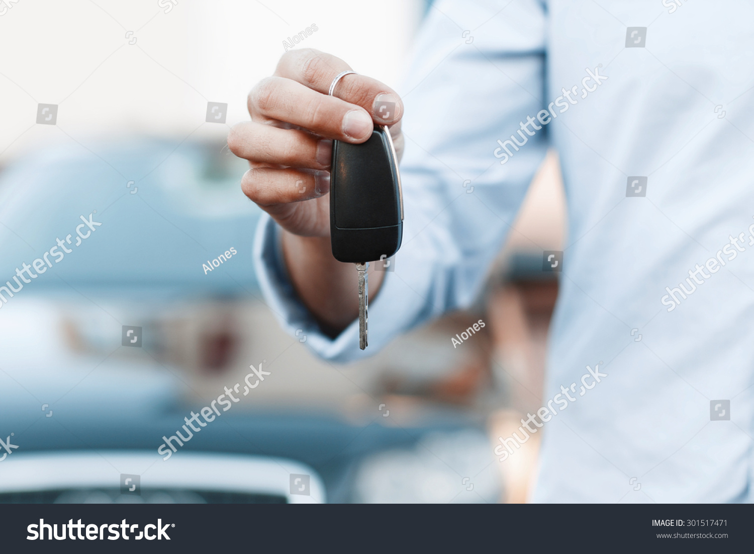 Businessman holding a car key.