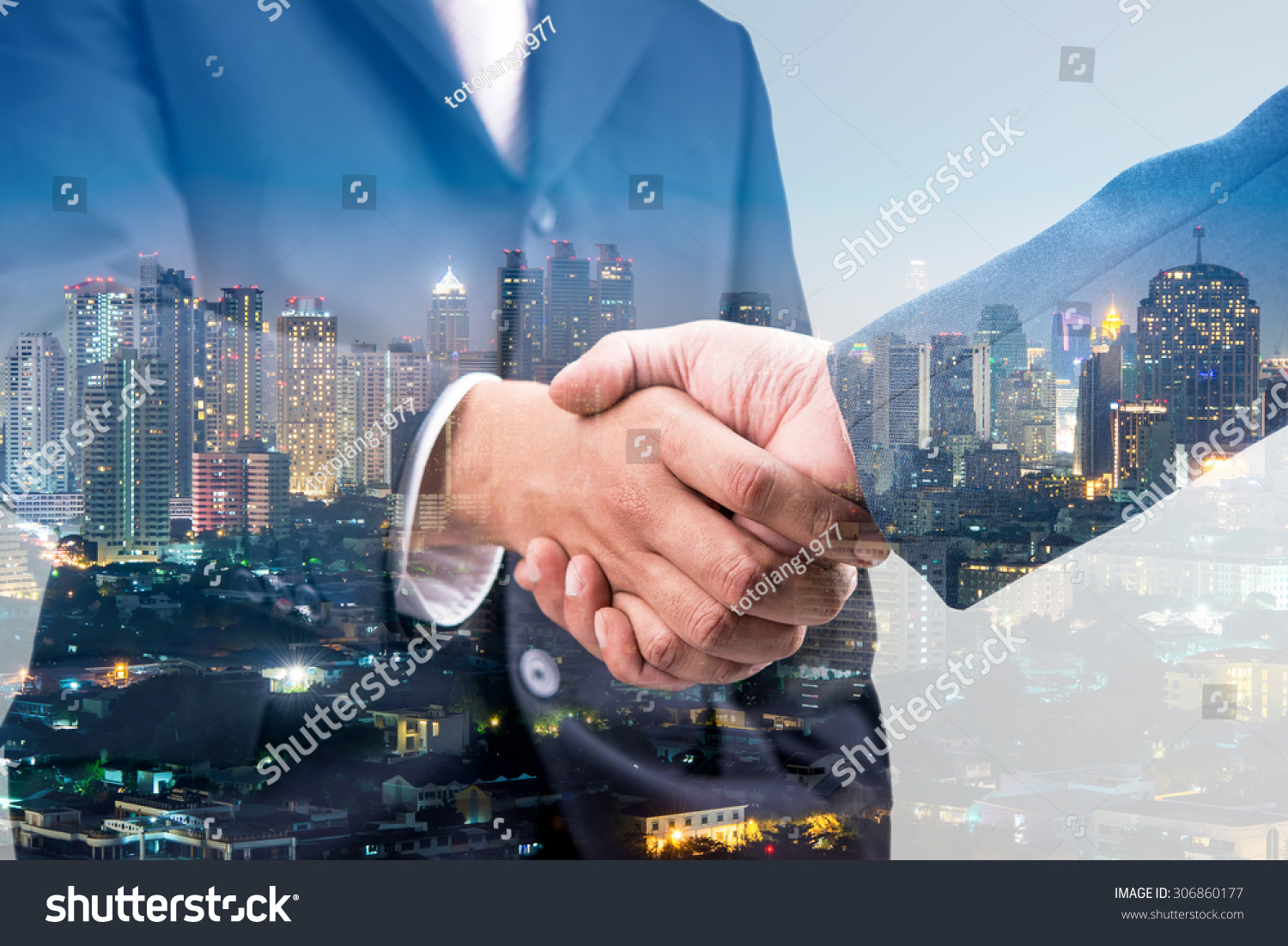 Double exposure of handshake and city 