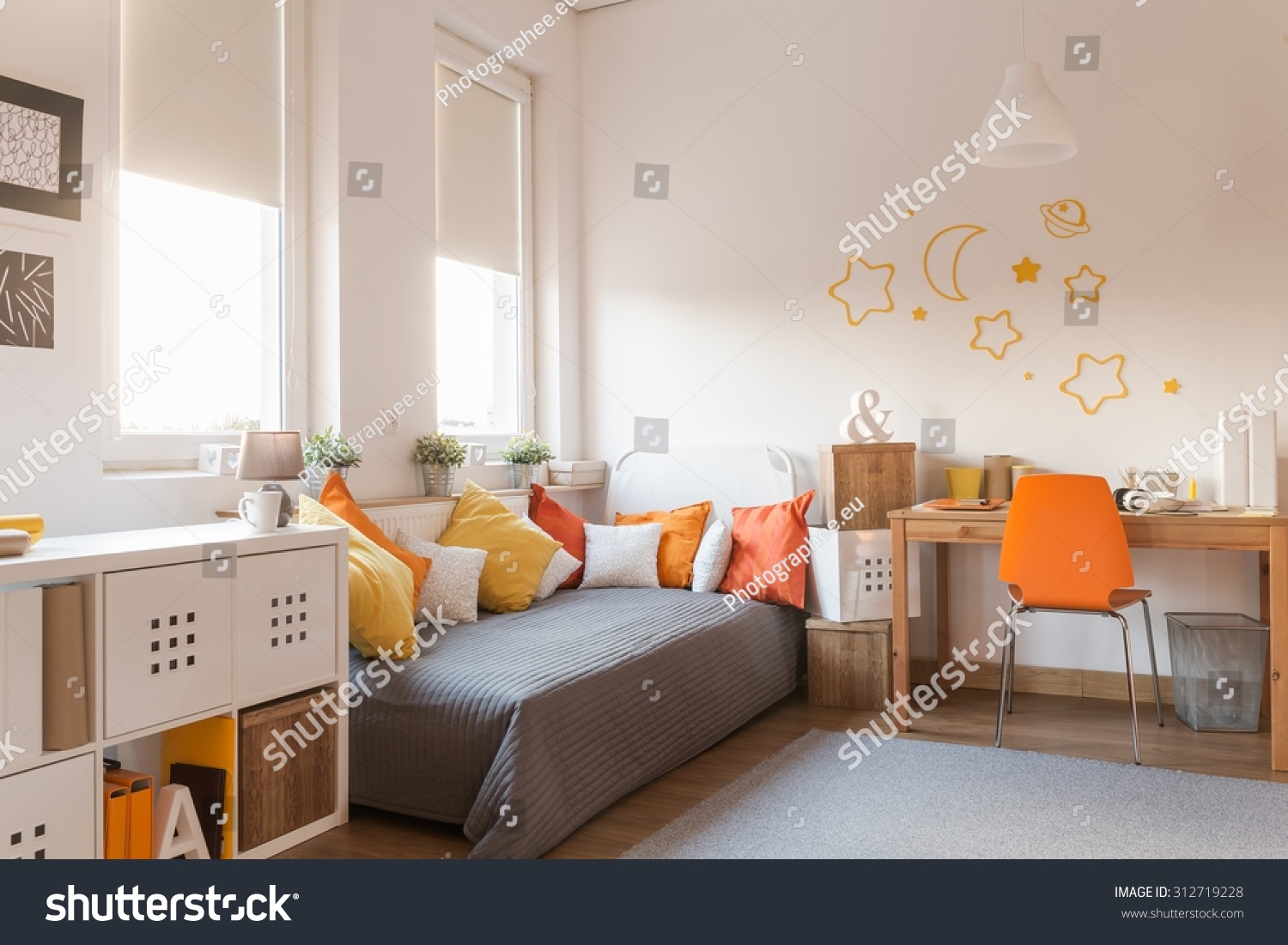 Yellow and orange accessories in modern teen room