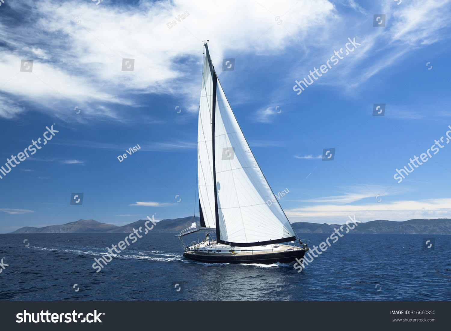 Sailing ship yachts with white sails in the Sea. Luxury boats.