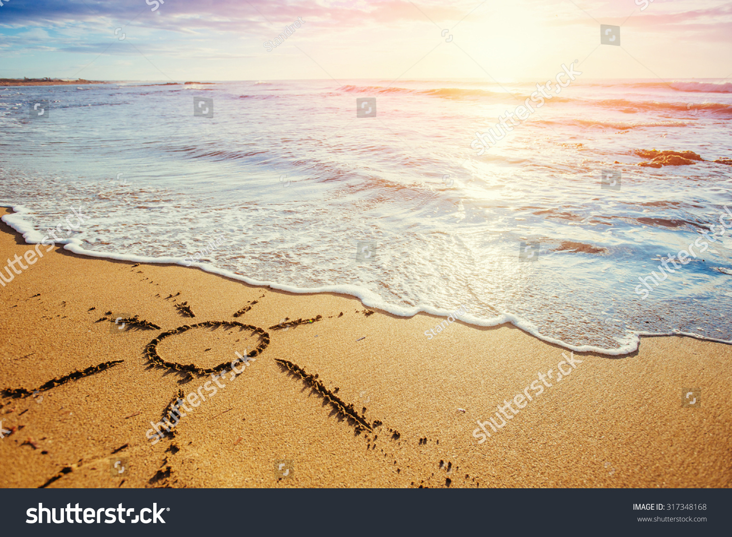 drawings in the sand on the beach.