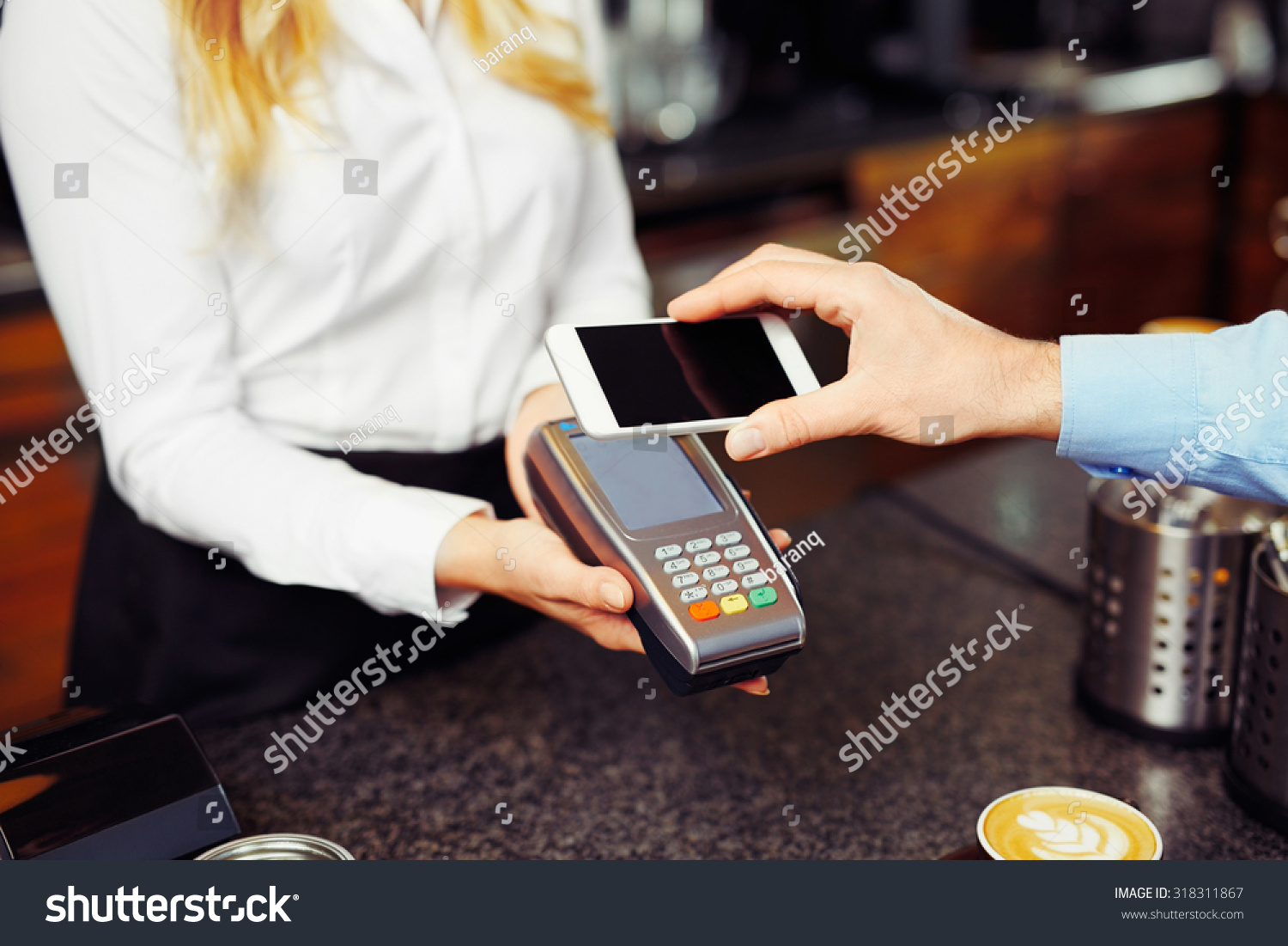 Paying with smartphone. Closeup of man making payment transaction with his mobile phone