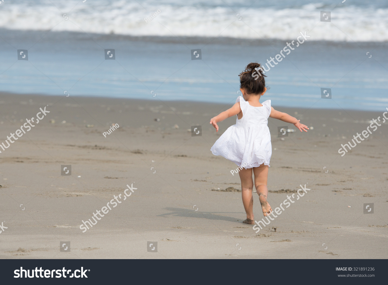 Girl playing on the beach