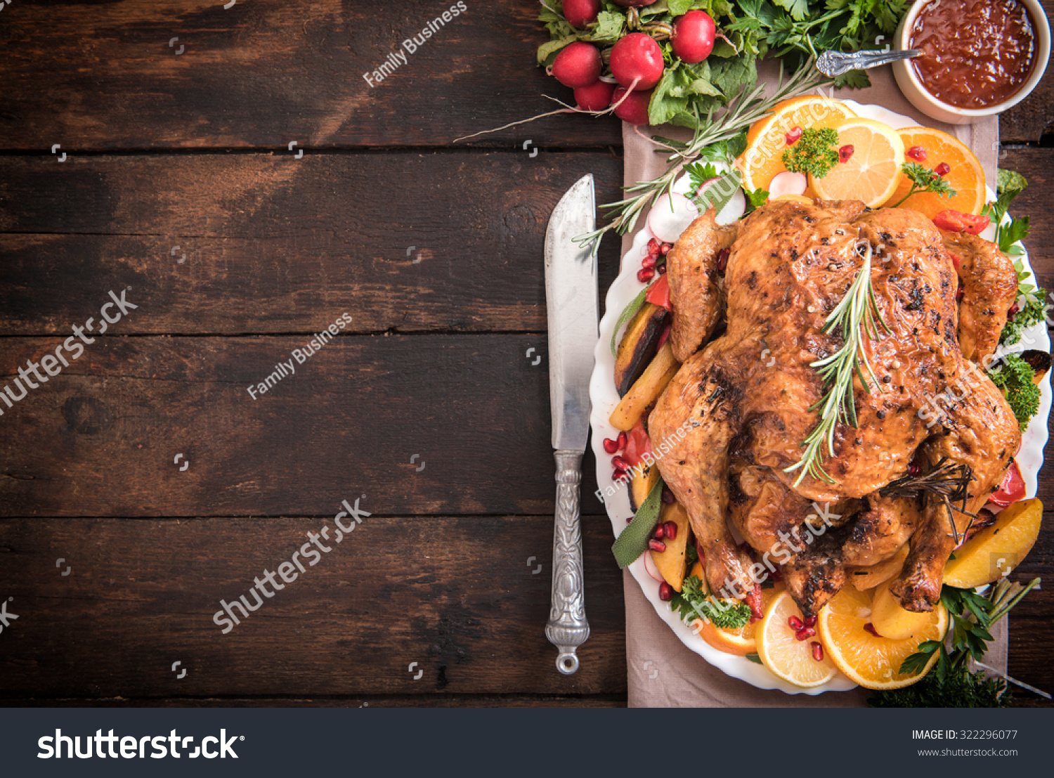 Served split roasted stuffed small turkey and vegetables from above and blank space 