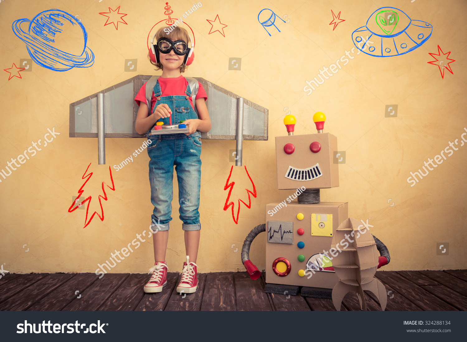 Happy kid playing with toy robot at home. Innovation technology and success concept