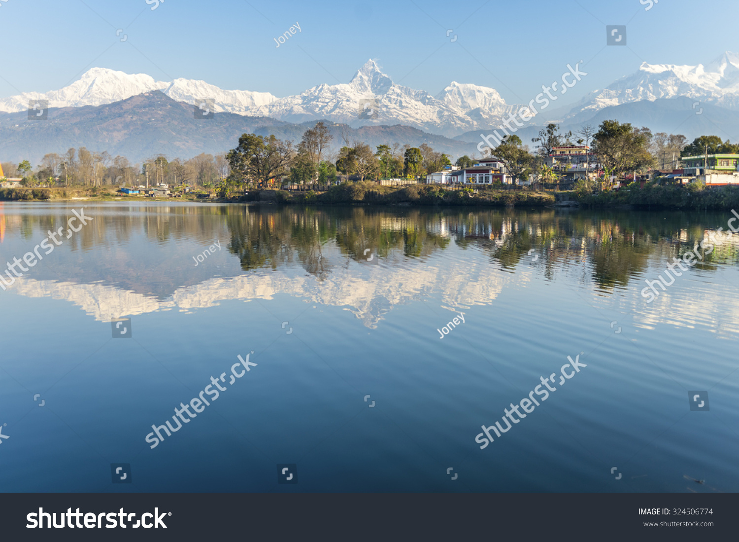 Lake Phewa in Pokhara Nepal with the Himalayan mountains in the background including Machhapuchhre and Annapurna