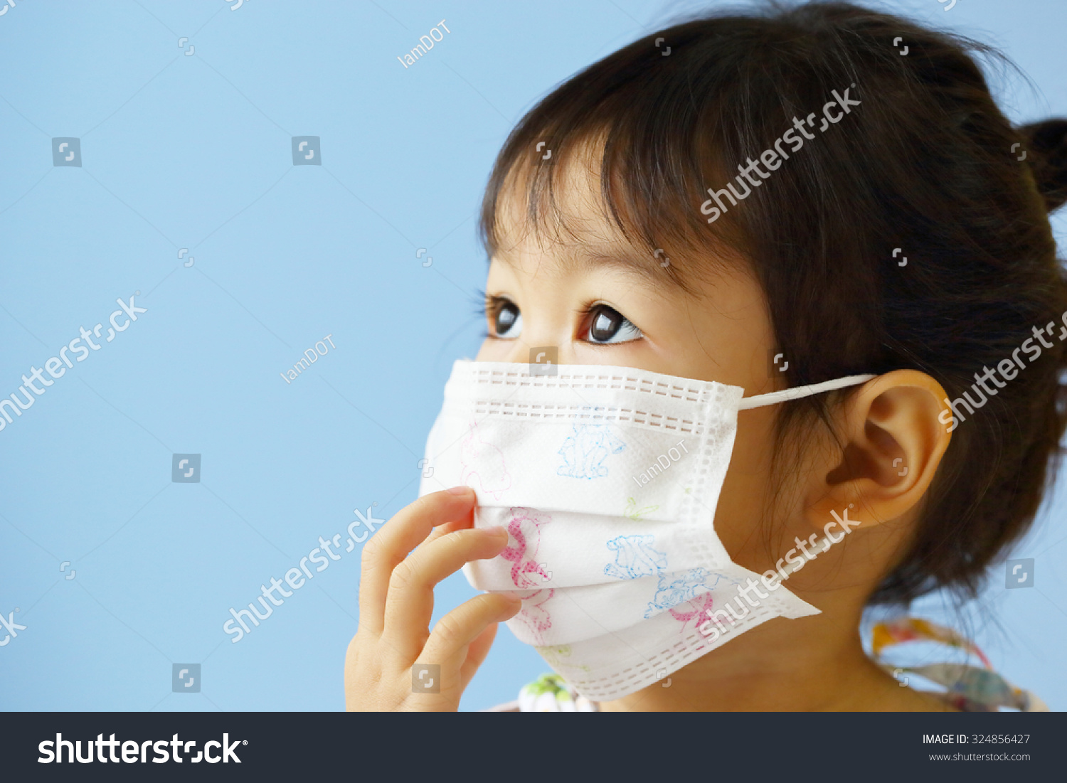 Asian Little Girl Gets Sick on Blue Background.
