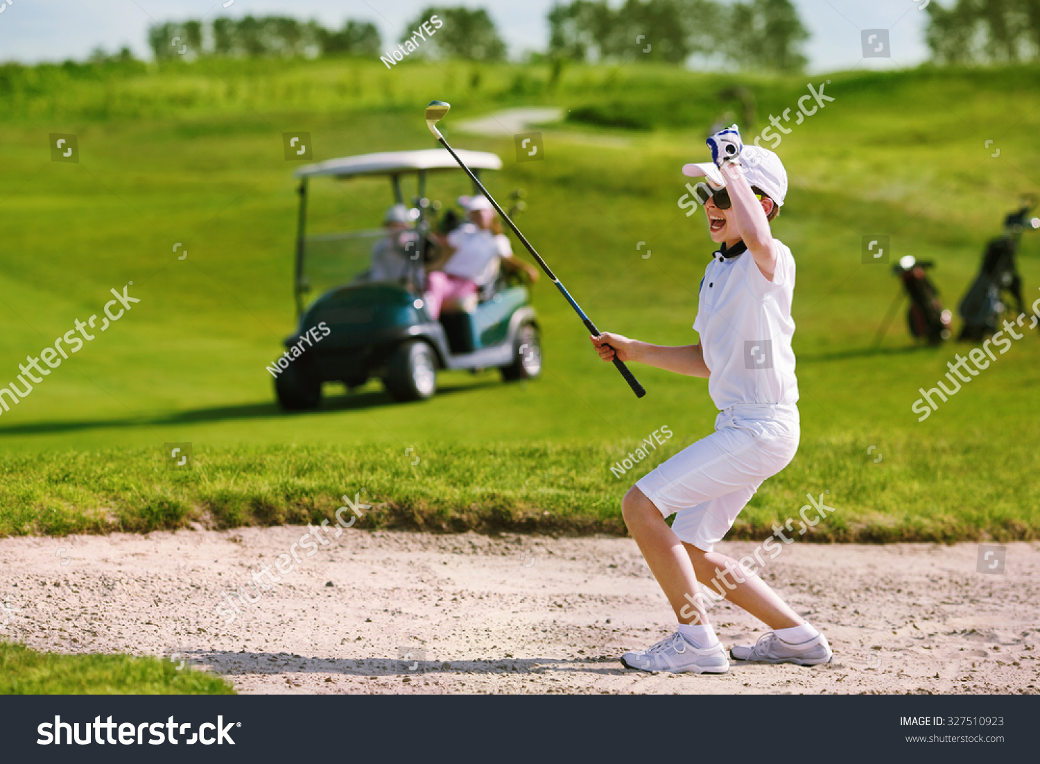 Boy playing golf and enjoing on the successful hit
