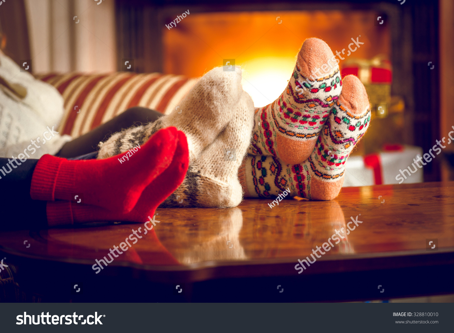 Closeup photo of family warming feet at fireplace