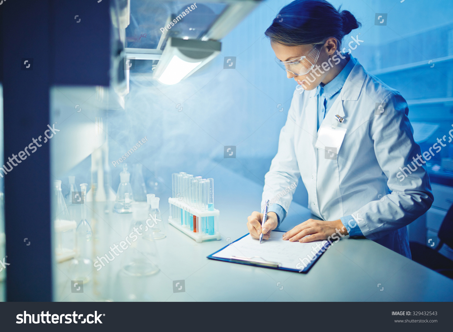 Female microbiologist learning characteristics of new substances in laboratory