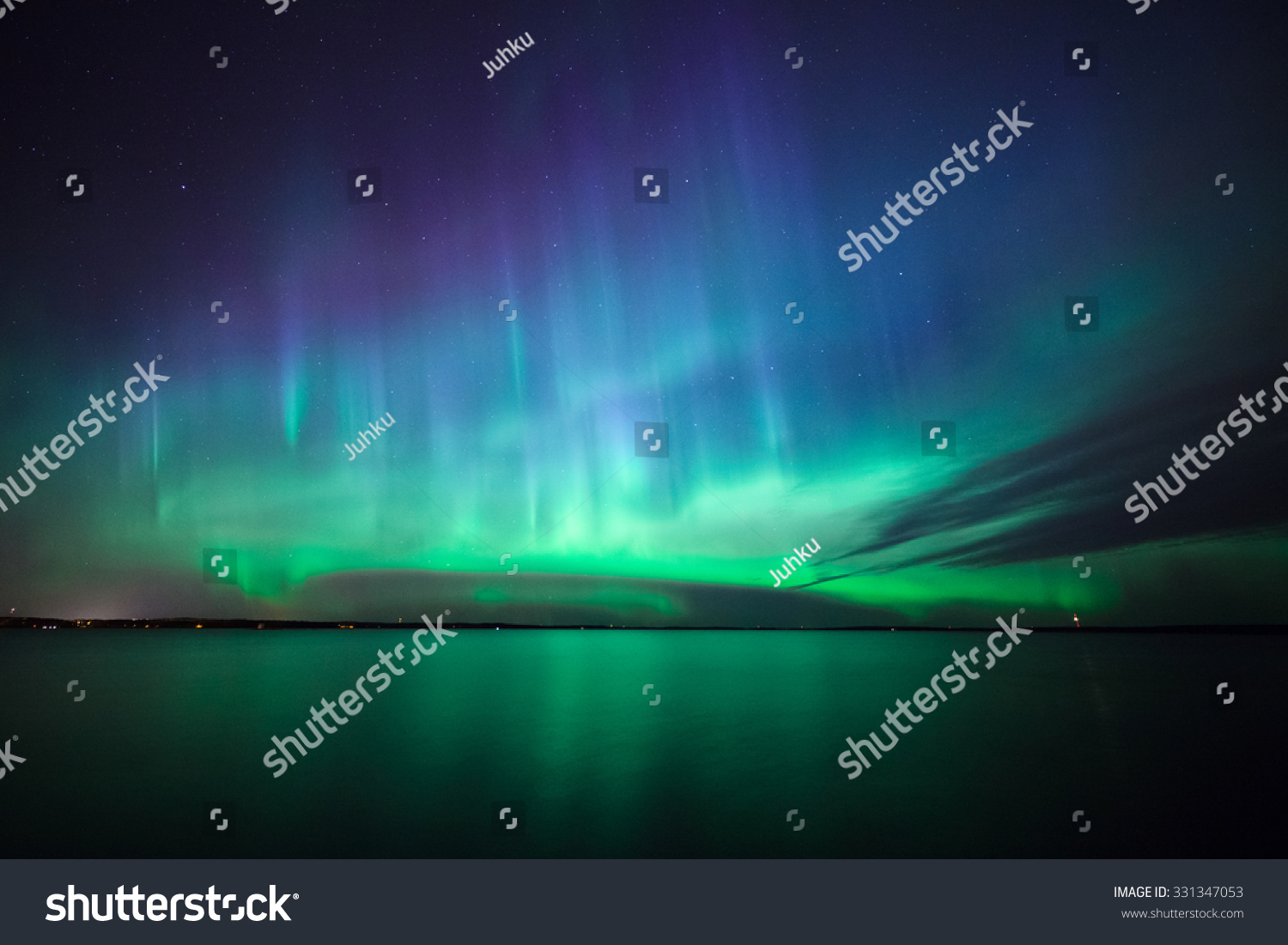 Beautiful northern lights aurora borealis over lake in finland