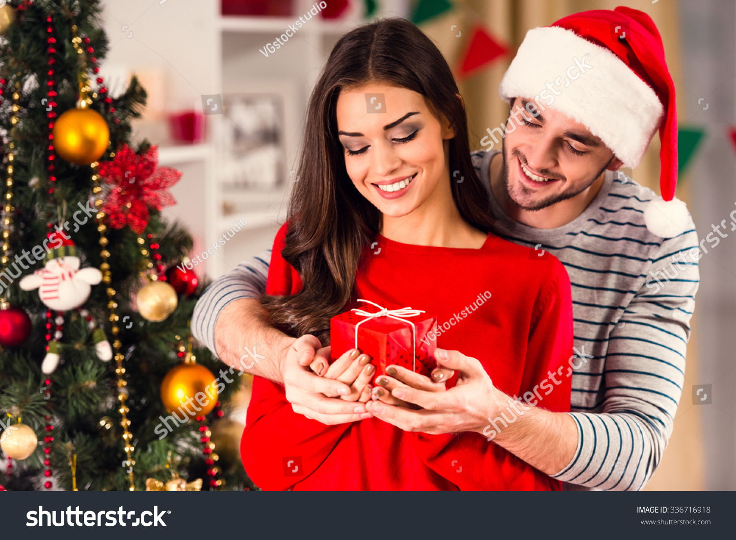 Merry Christmas. Young couple celebrating Christmas at home