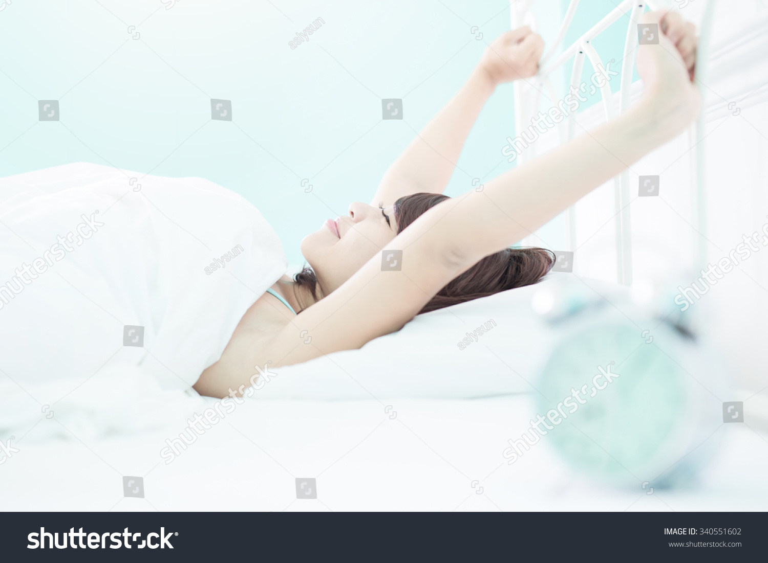 smile woman wake up on the bed in the morning   asian girl