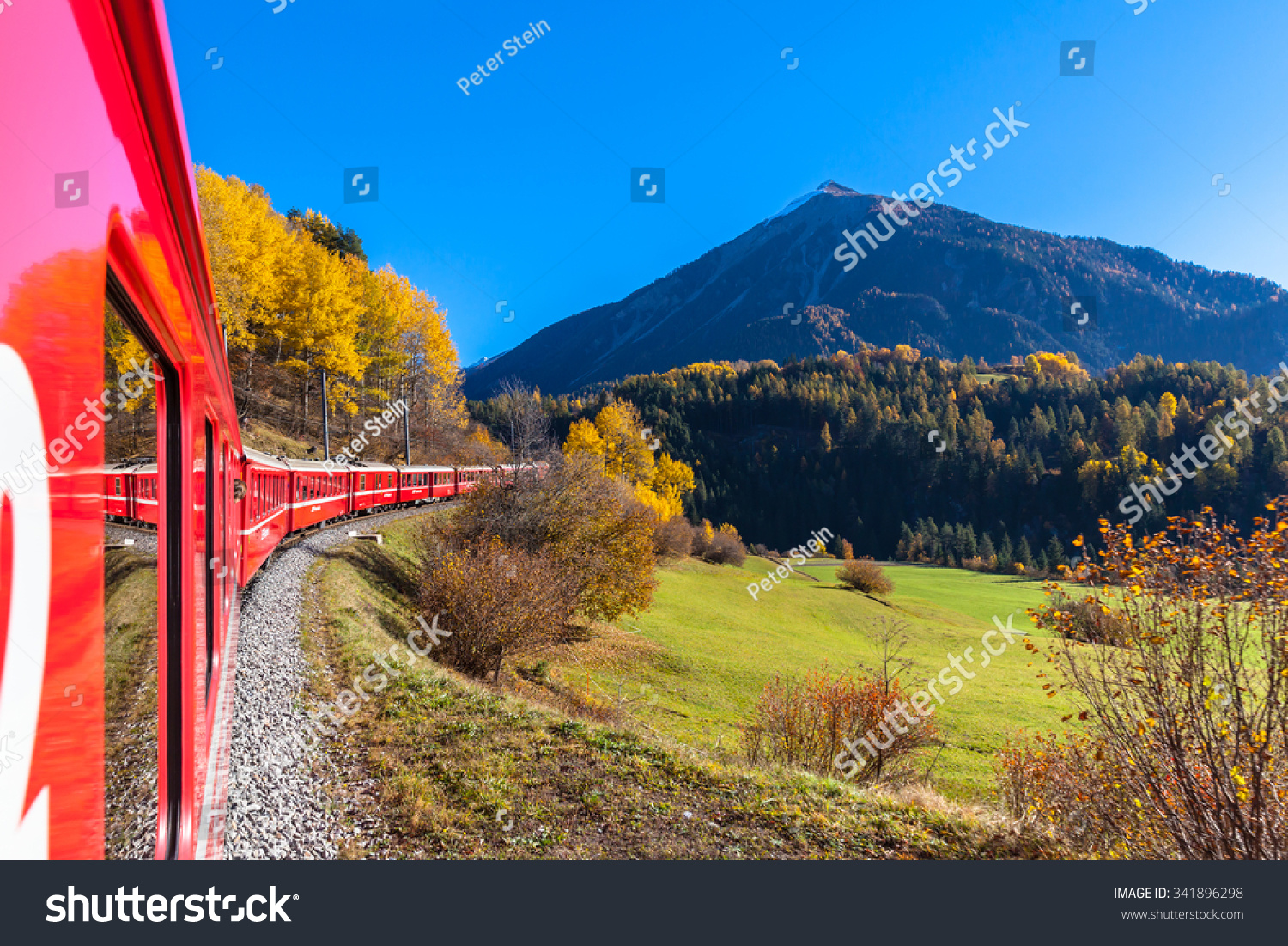 Travel with train of Rhaetian Railway in golden autumn through the line of Glacier Express in Engadin Canton of Grisons Switzerland.